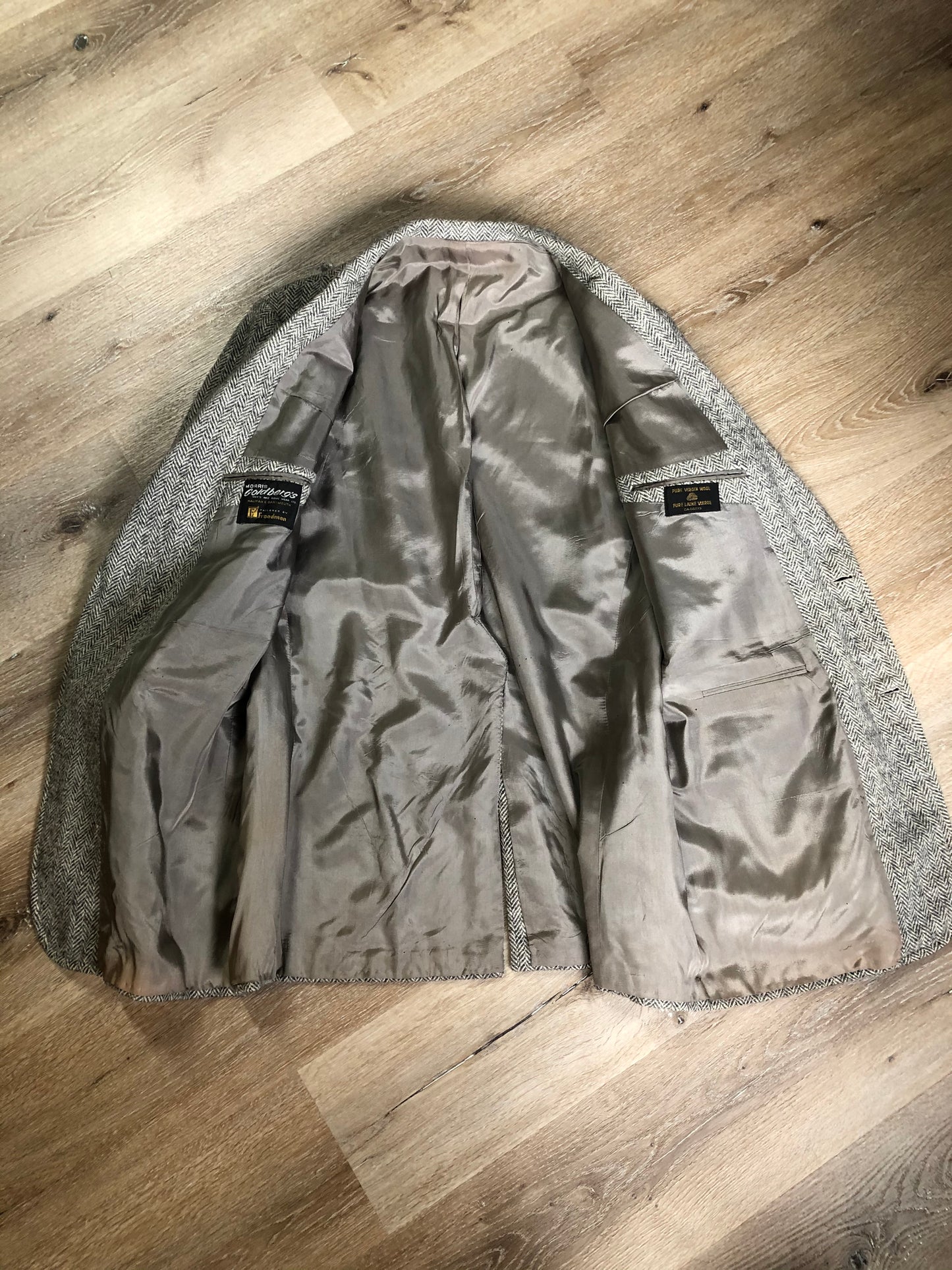 Kingspier Vintage - Morris Goldberg’s grey herringbone 100% wool tweed jacket. This jacket is a two button, notch lapel with two flap pockets, a breast pocket and three inside pockets. Made in Halifax, Nova Scotia.