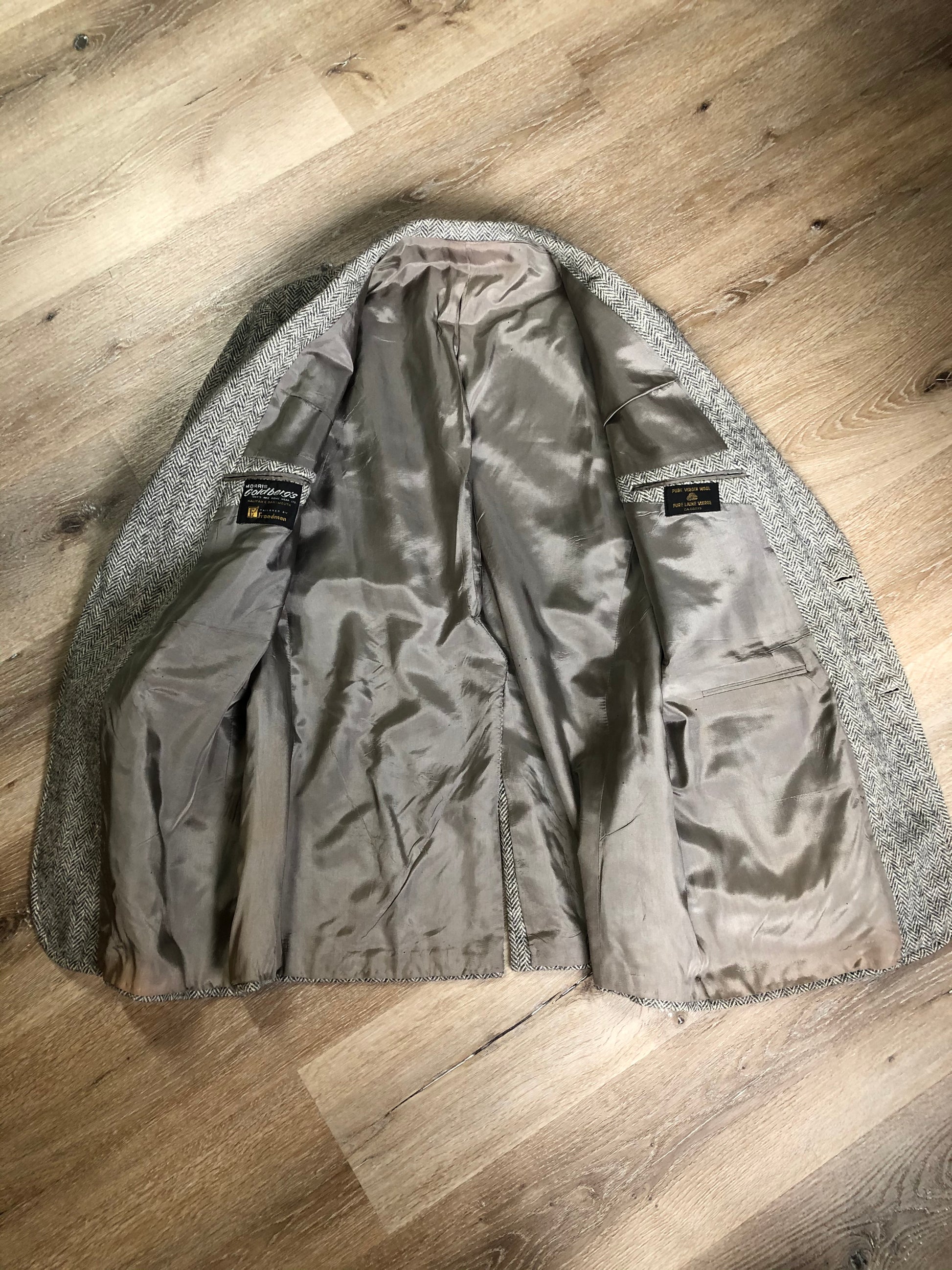 Kingspier Vintage - Morris Goldberg’s grey herringbone 100% wool tweed jacket. This jacket is a two button, notch lapel with two flap pockets, a breast pocket and three inside pockets. Made in Halifax, Nova Scotia.
