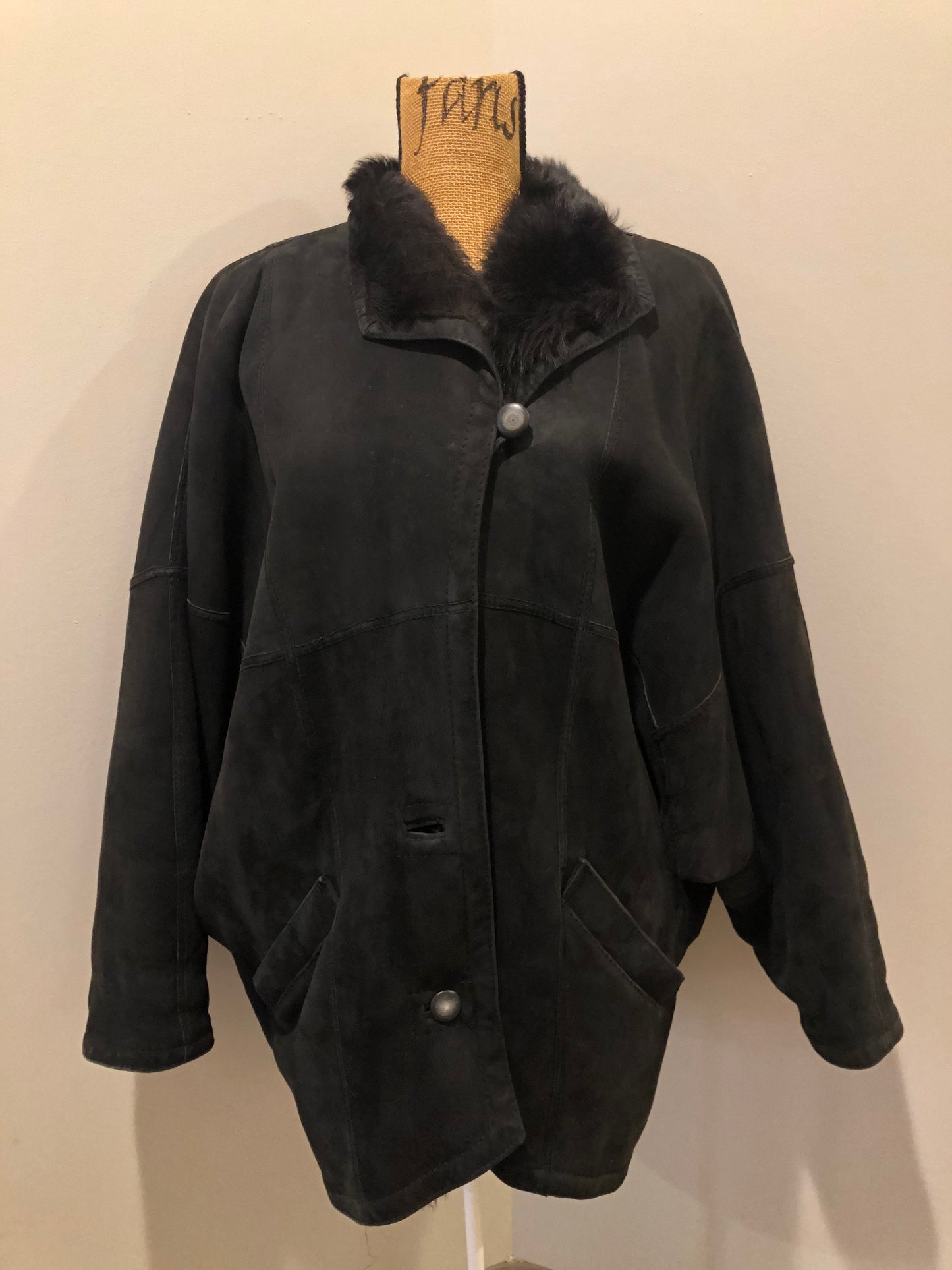 Kingspier Vintage - Black shearling coat with shearling lining, button closures and slash pockets.