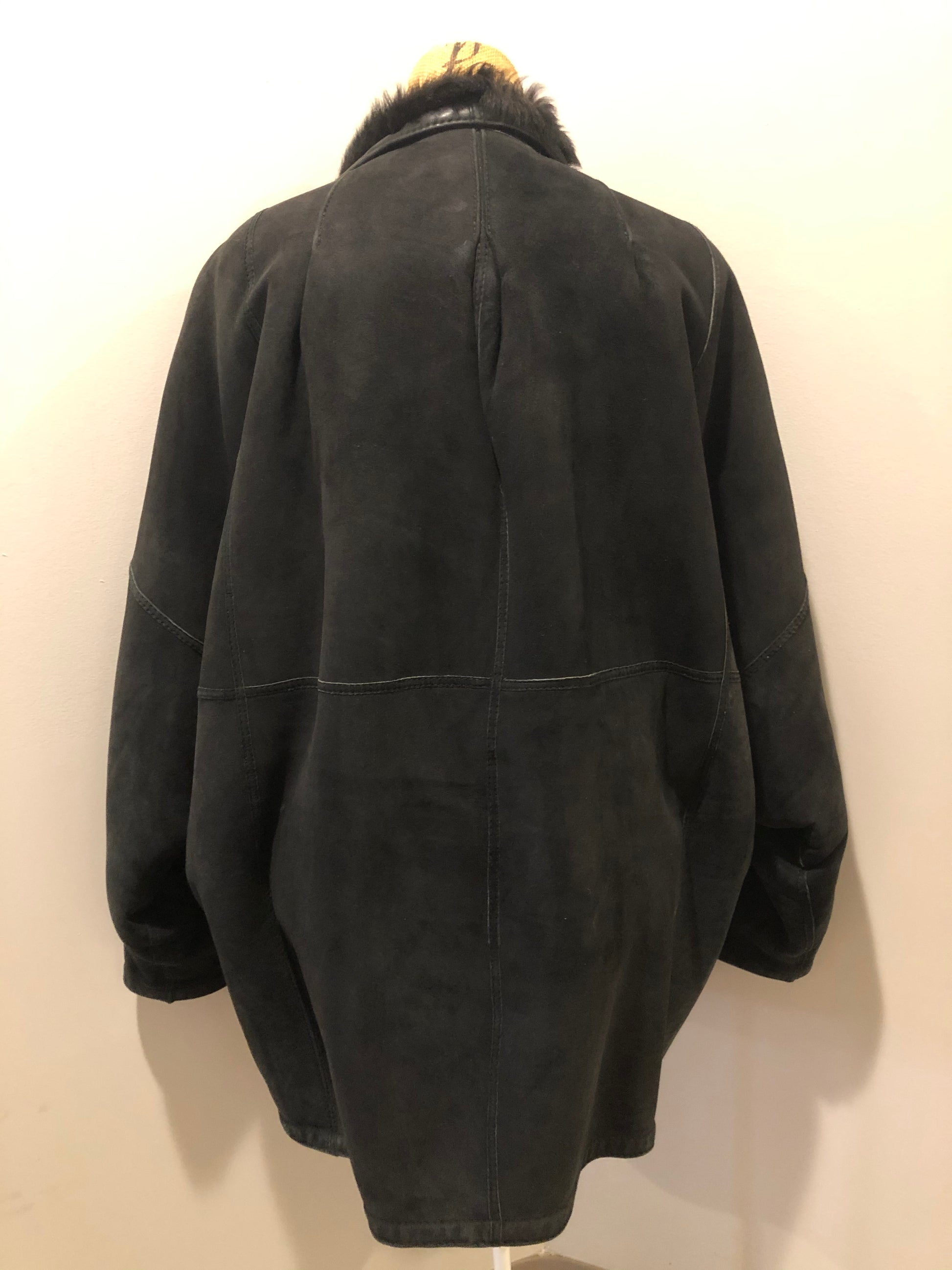 Kingspier Vintage - Black shearling coat with shearling lining, button closures and slash pockets.