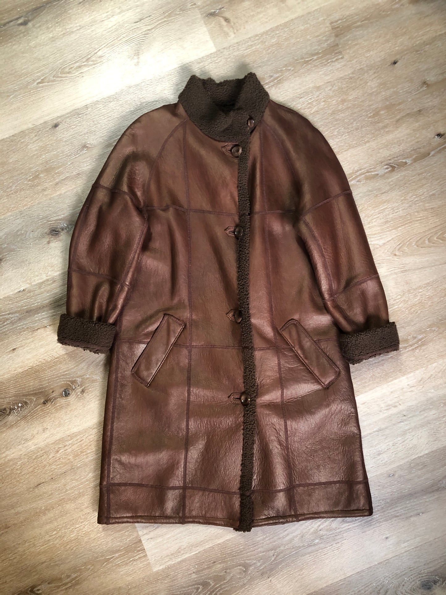 Kingspier Vintage - Rosa Mori by Irma Taylor medium brown shearling coat. This coat features a bronze iridescent finish, shearling trim and lining, button closures and slash pockets. Made in Montreal, Canada, Size medium.