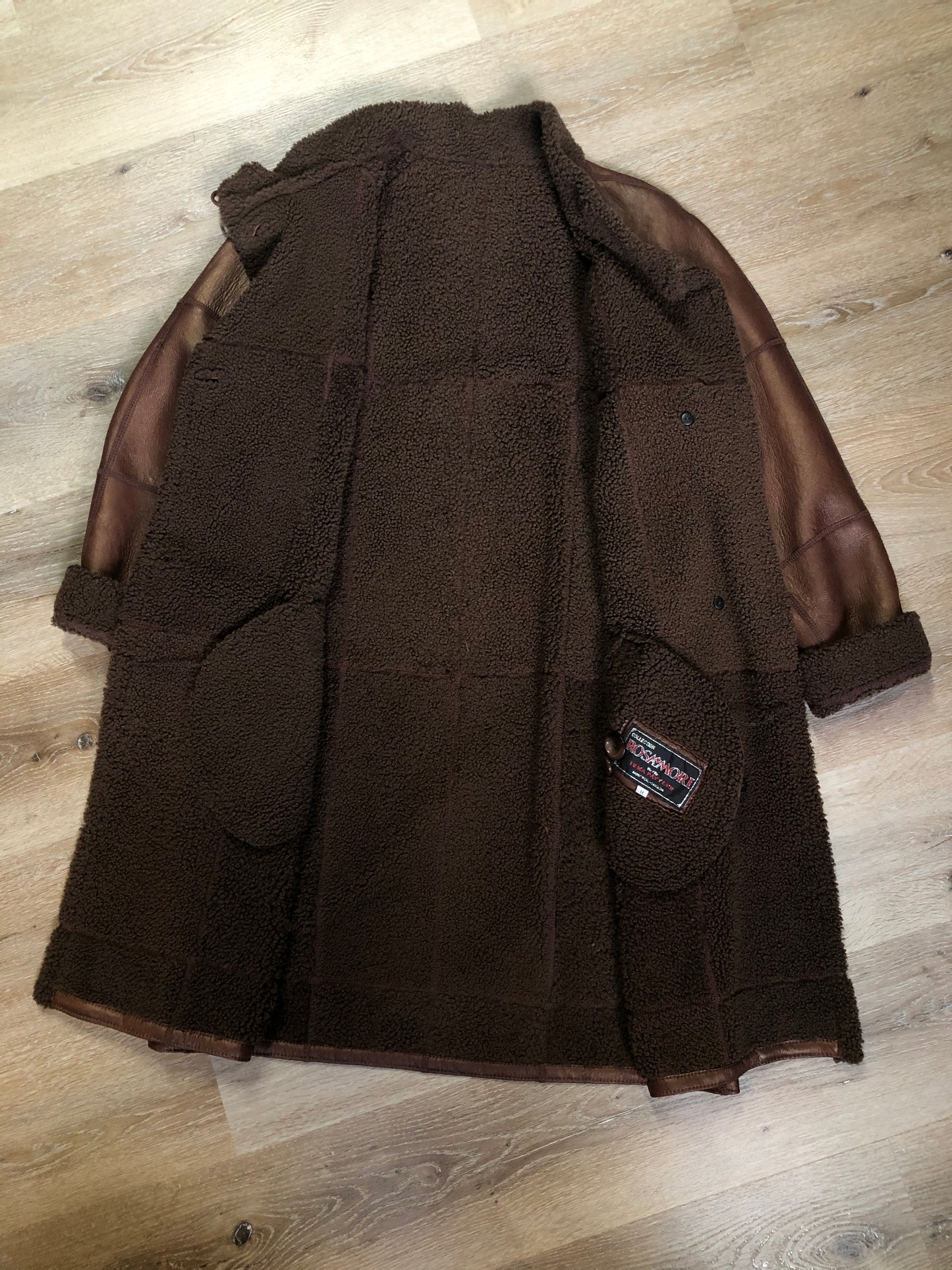 Kingspier Vintage - Rosa Mori by Irma Taylor medium brown shearling coat. This coat features a bronze iridescent finish, shearling trim and lining, button closures and slash pockets. Made in Montreal, Canada, Size medium.
