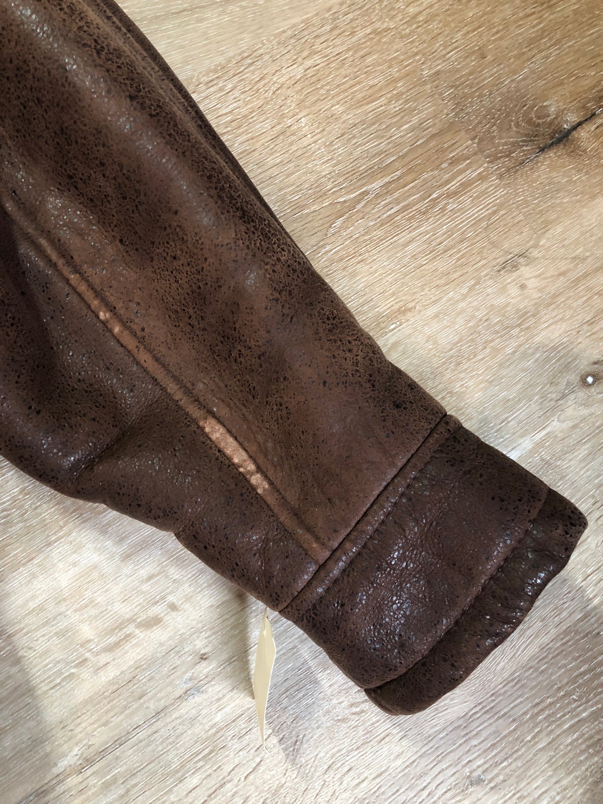 Kingspier Vintage - Jean Claude Poitras medium brown shearling coat. This coat features a speckled texture, shearling lining, zipper and snap closures, one zip pocket on the chest and two welt pockets. Size medium.