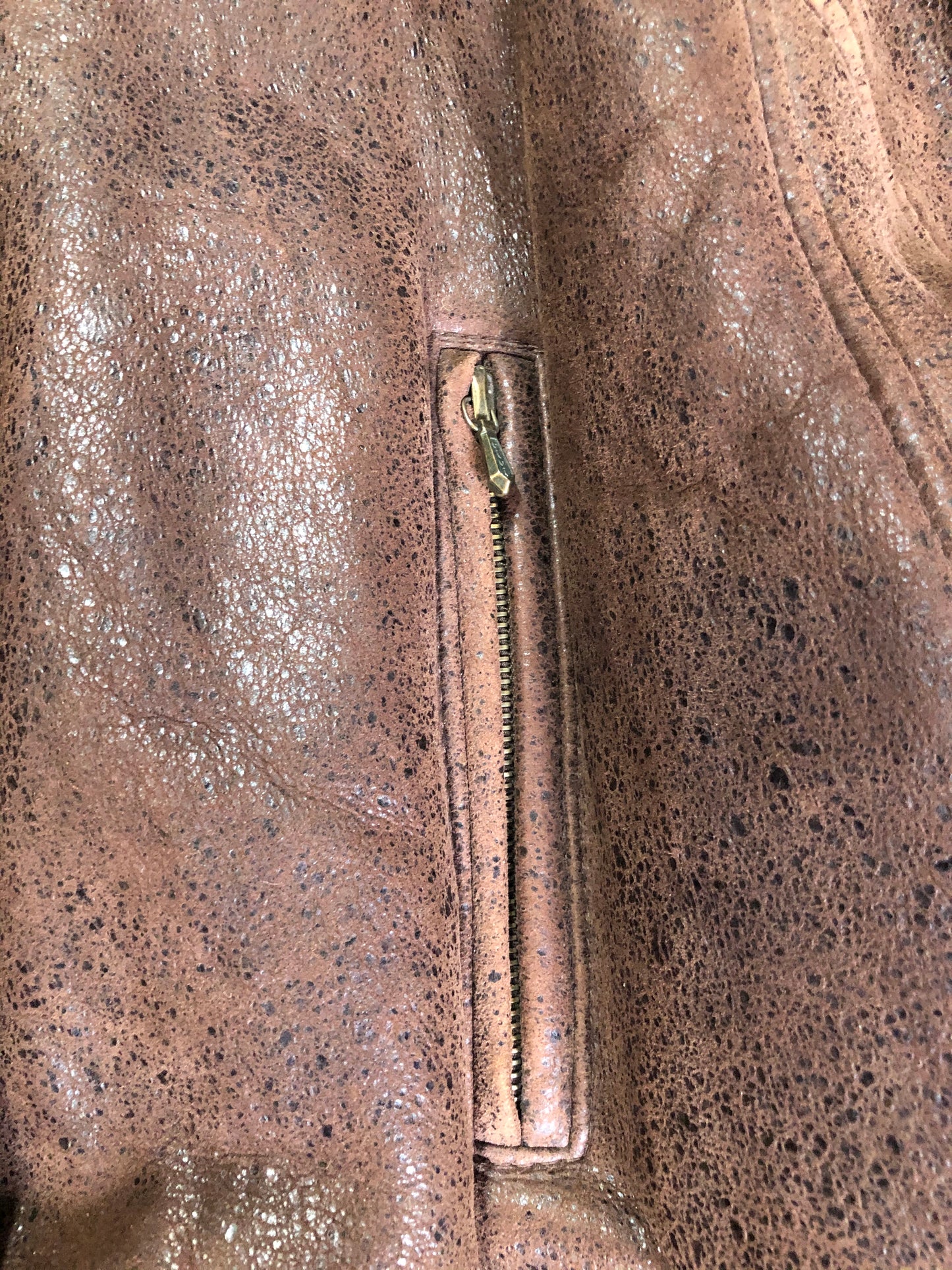 Kingspier Vintage - Jean Claude Poitras medium brown shearling coat. This coat features a speckled texture, shearling lining, zipper and snap closures, one zip pocket on the chest and two welt pockets. Size medium.