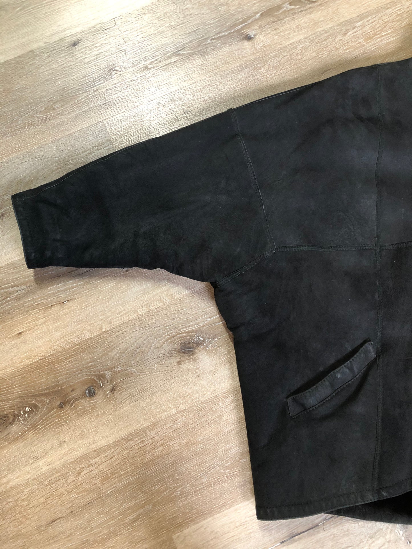 Kingspier Vintage - Black shearling coat with shearling lining, button closures and slash pockets.