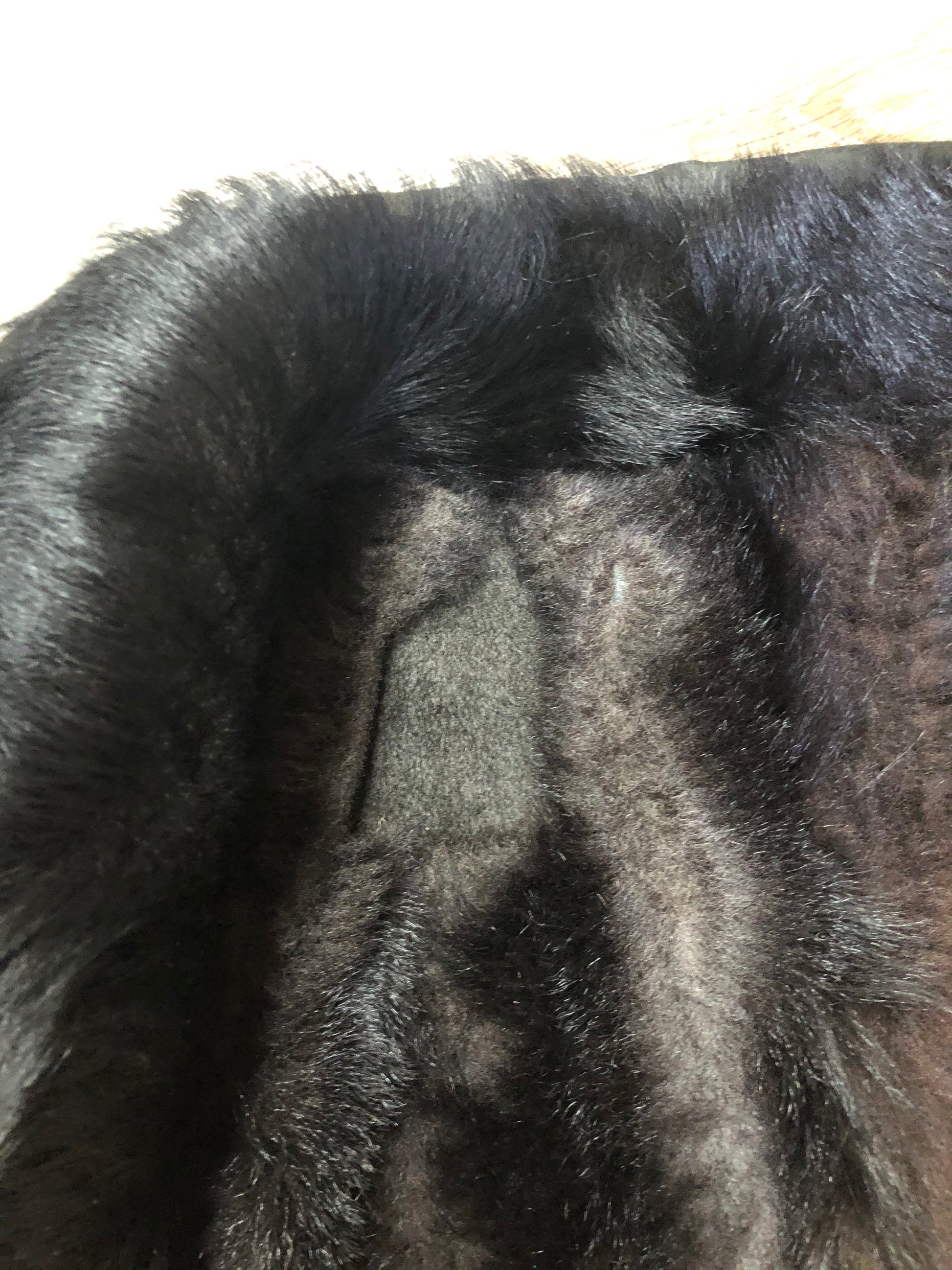 Kingspier Vintage - Black shearling coat with shearling lining, button closures and slash pockets.