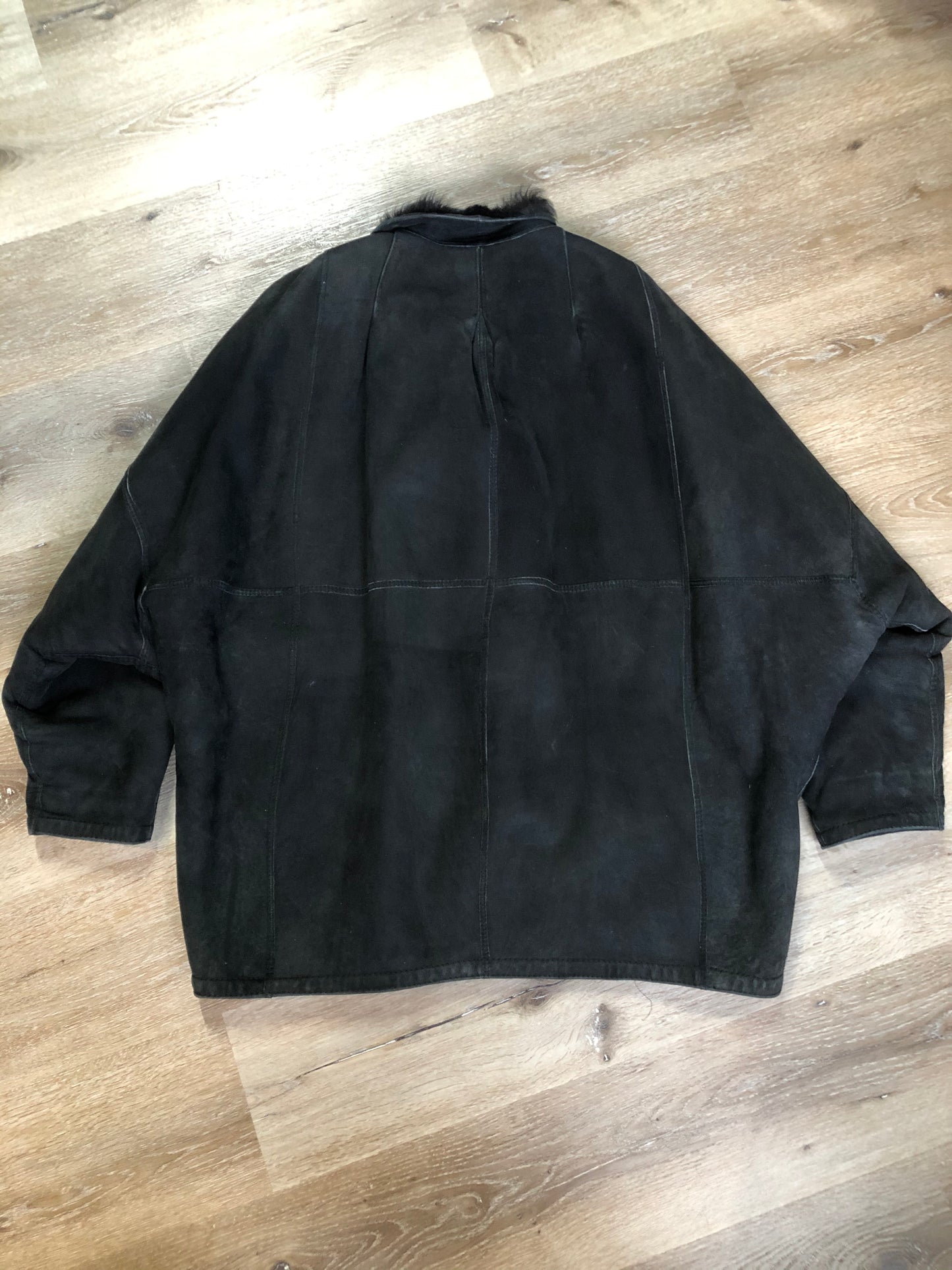 Kingspier Vintage - Black shearling coat with shearling lining, button closures and slash pockets.