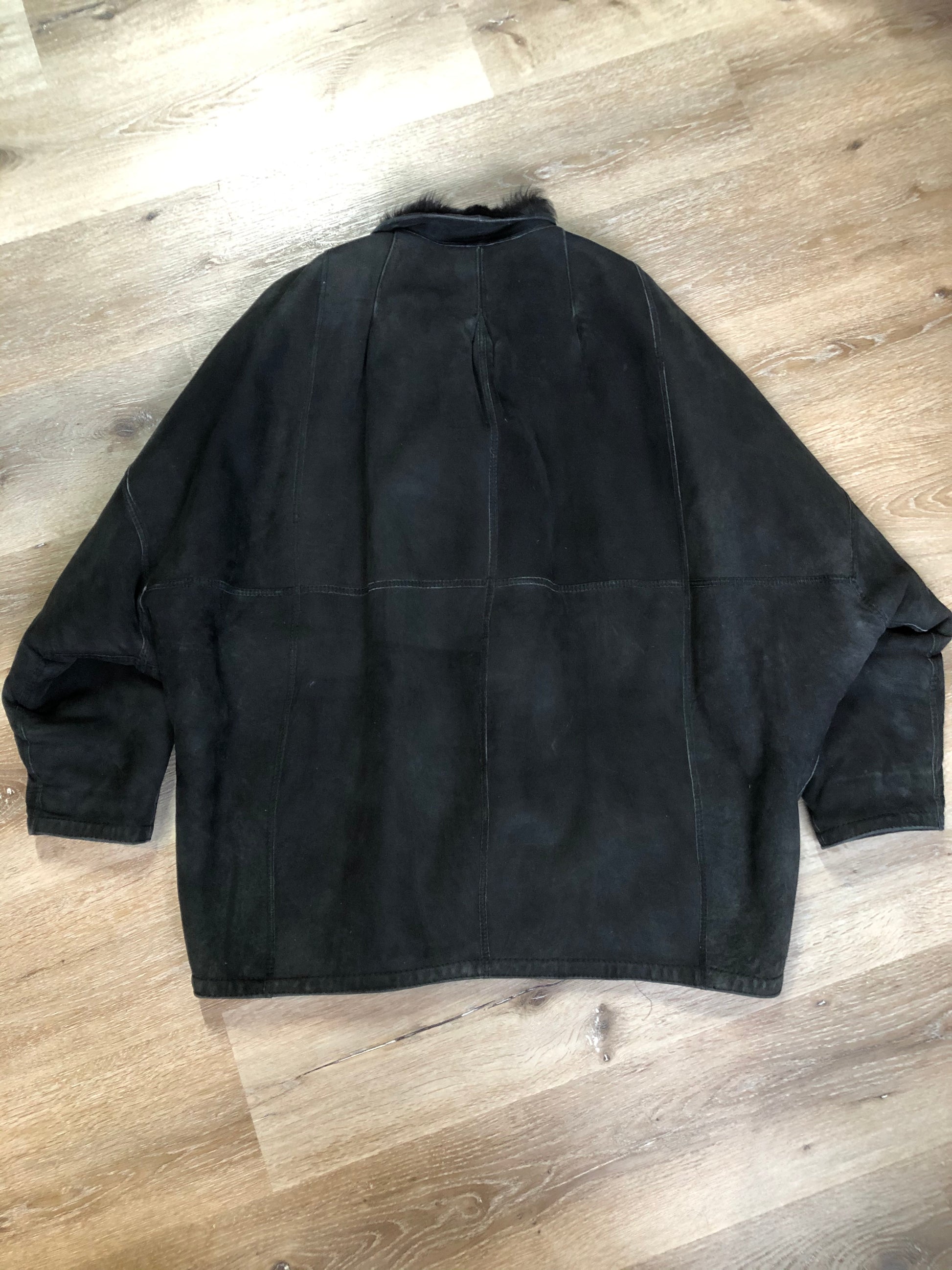 Kingspier Vintage - Black shearling coat with shearling lining, button closures and slash pockets.