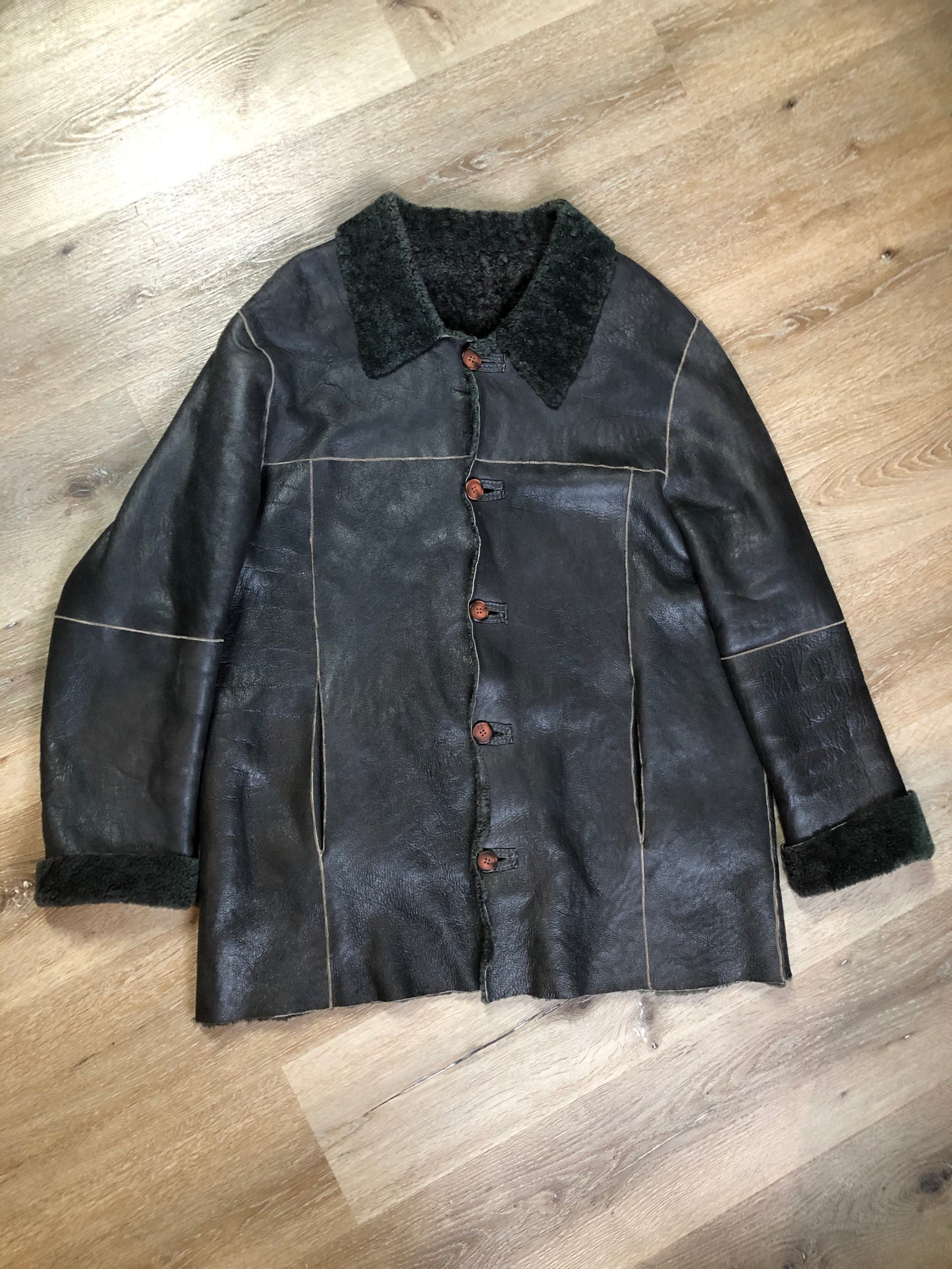 Kingspier Vintage - Reilly Olmes espresso brown coat with grey/ green shearling trim and lining, button closures and vertical pockets. Made in Argentina. Size large.