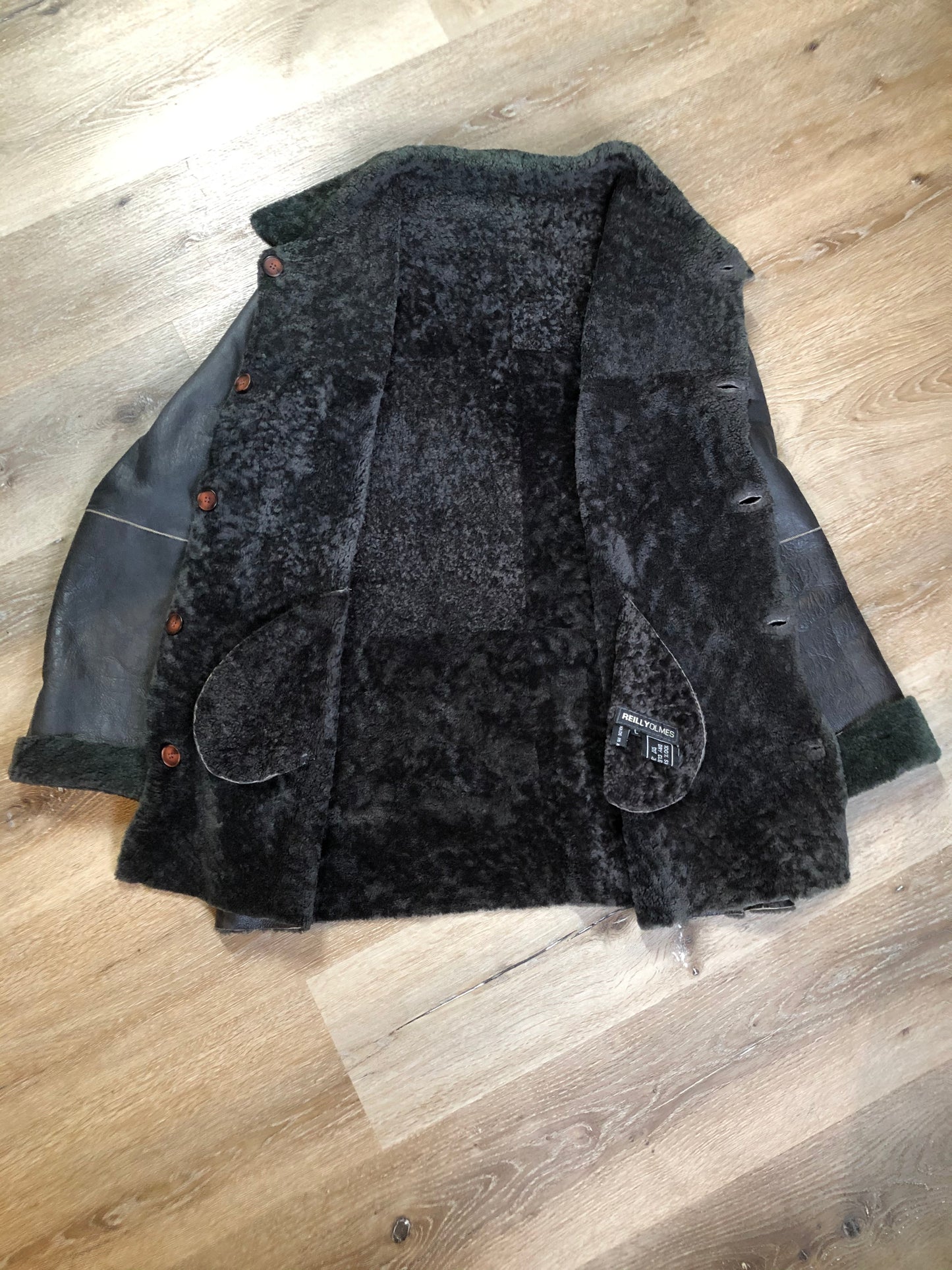 Kingspier Vintage - Reilly Olmes espresso brown coat with grey/ green shearling trim and lining, button closures and vertical pockets. Made in Argentina. Size large.