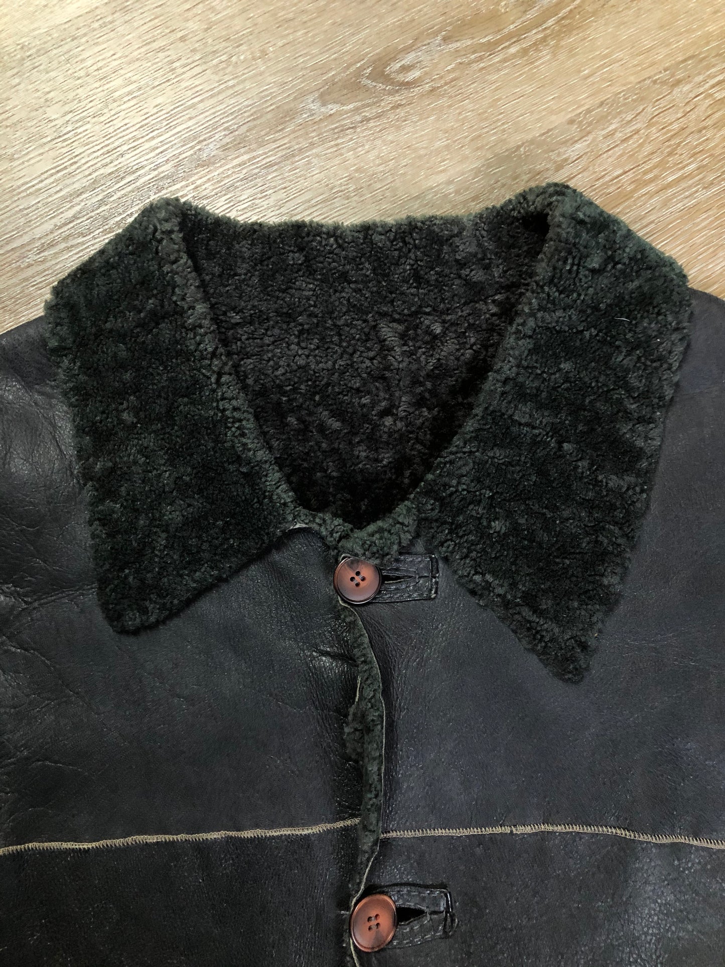 Kingspier Vintage - Reilly Olmes espresso brown coat with grey/ green shearling trim and lining, button closures and vertical pockets. Made in Argentina. Size large.