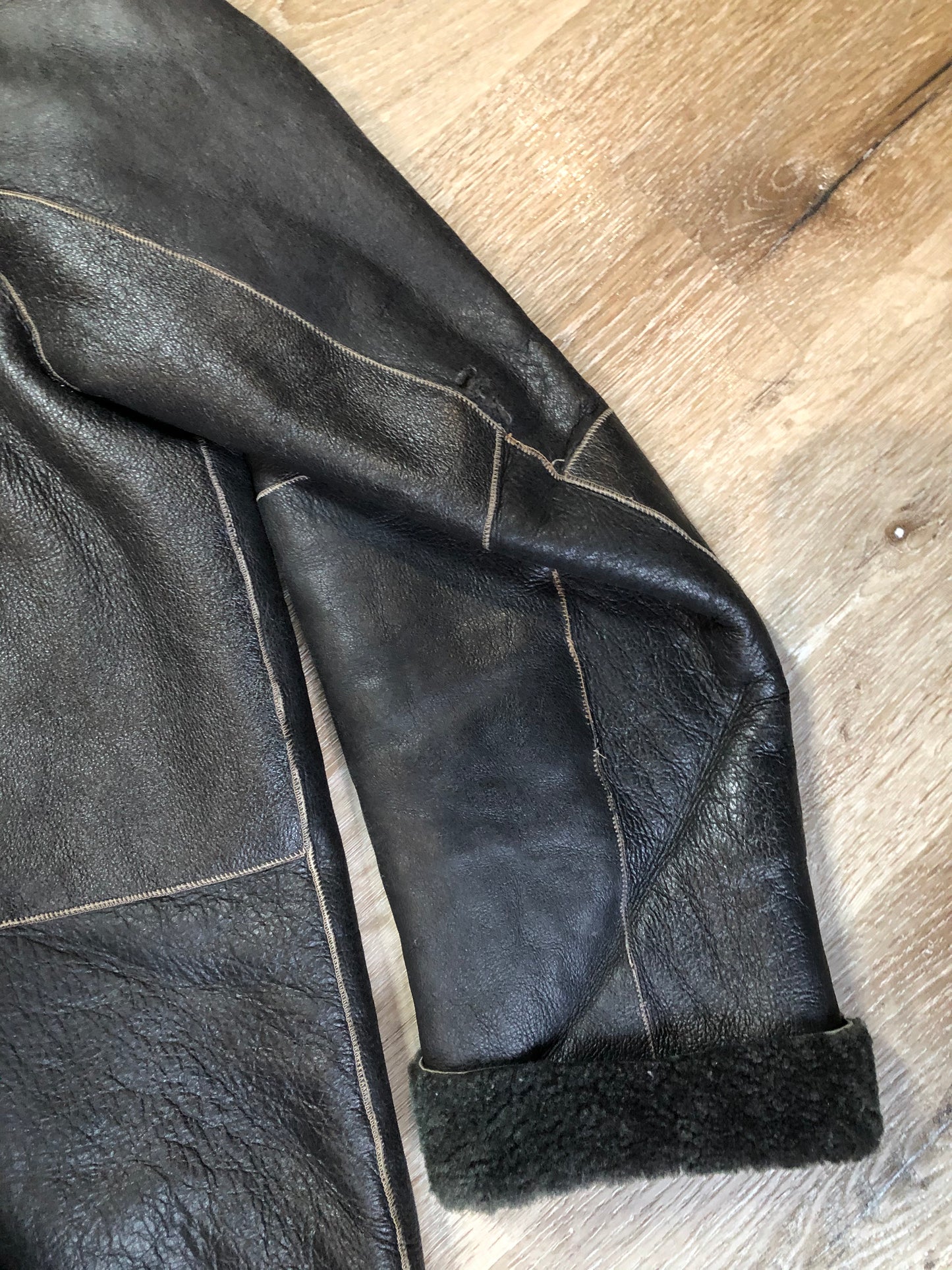 Kingspier Vintage - Reilly Olmes espresso brown coat with grey/ green shearling trim and lining, button closures and vertical pockets. Made in Argentina. Size large.