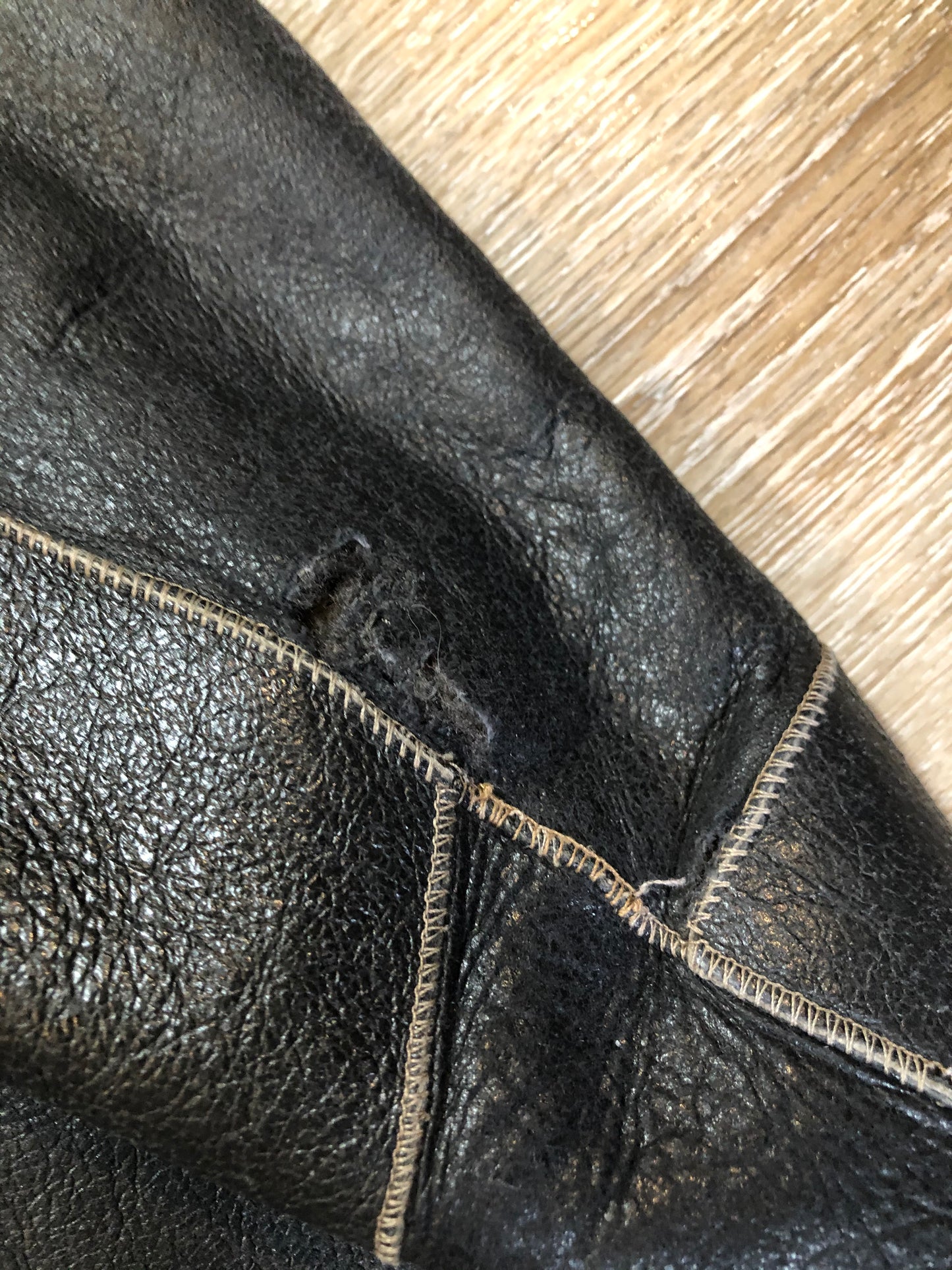 Kingspier Vintage - Reilly Olmes espresso brown coat with grey/ green shearling trim and lining, button closures and vertical pockets. Made in Argentina. Size large.