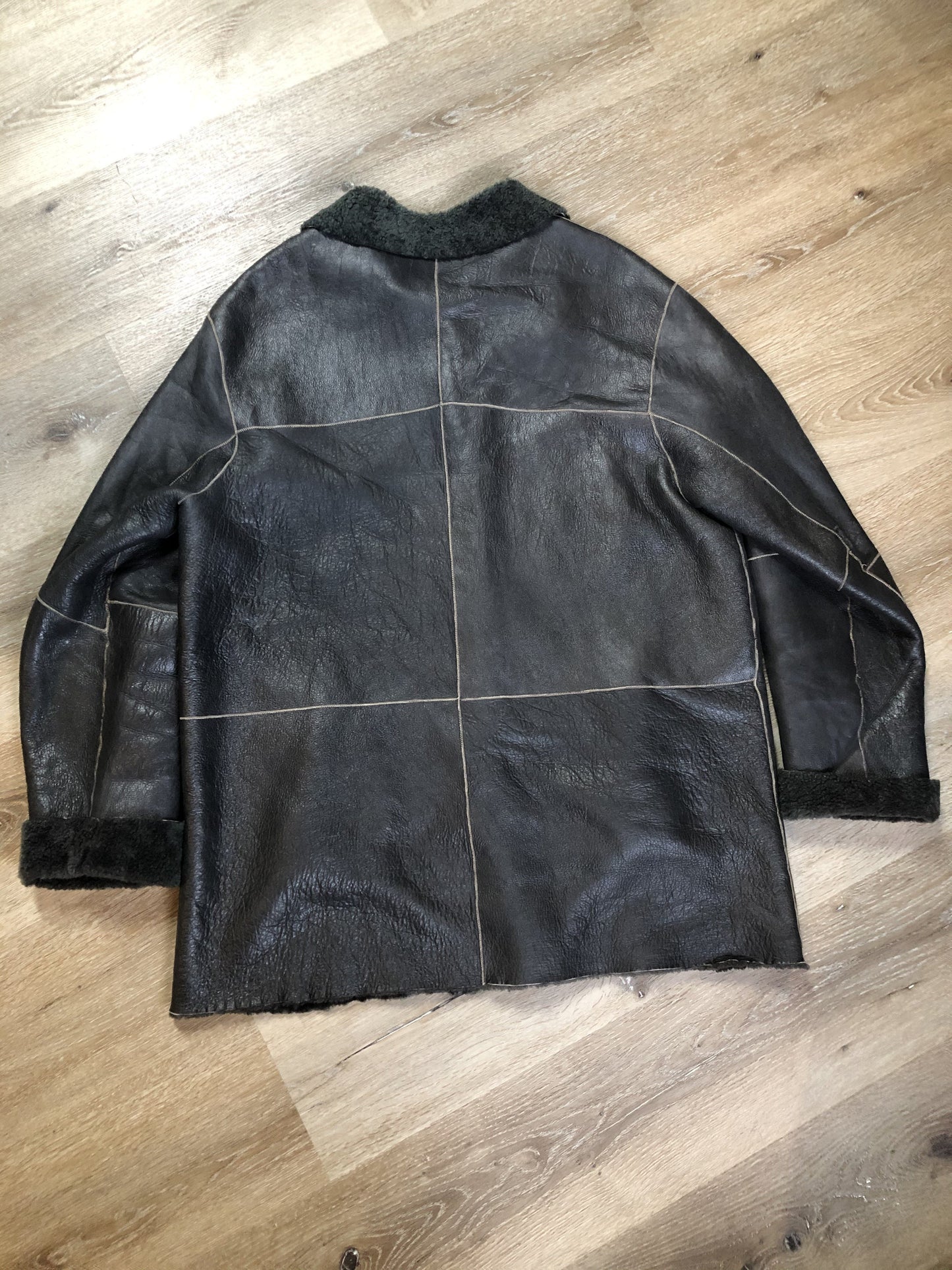Kingspier Vintage - Reilly Olmes espresso brown coat with grey/ green shearling trim and lining, button closures and vertical pockets. Made in Argentina. Size large.