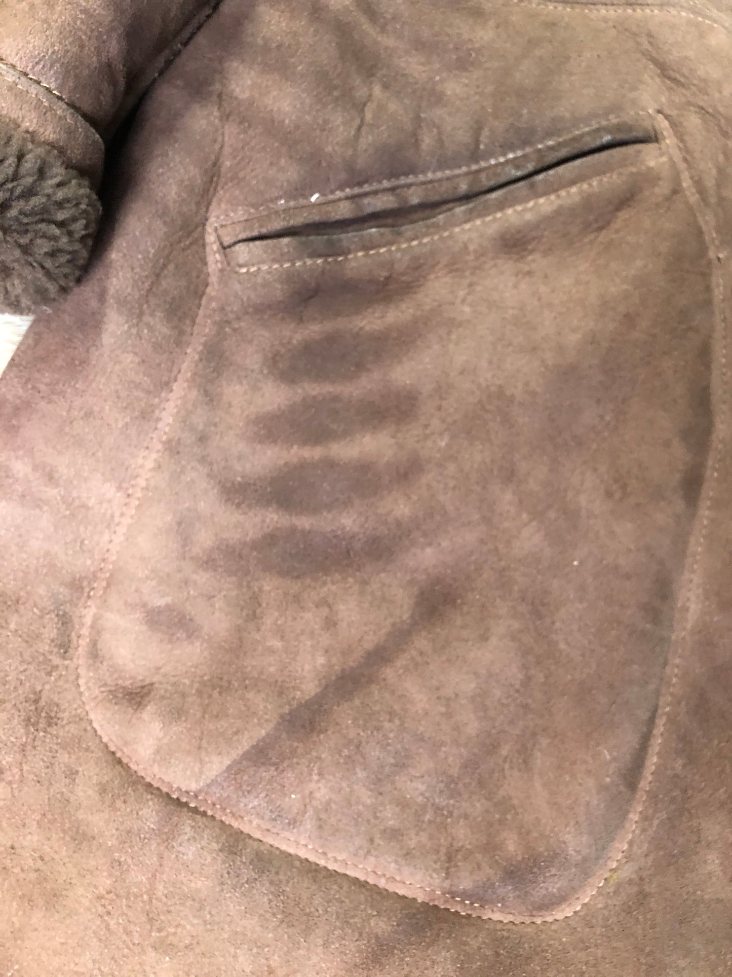 Kingspier Vintage - Bovet medium brown shearling coat. This coat features shearling trim and lining, wooden button closures and patch pockets.