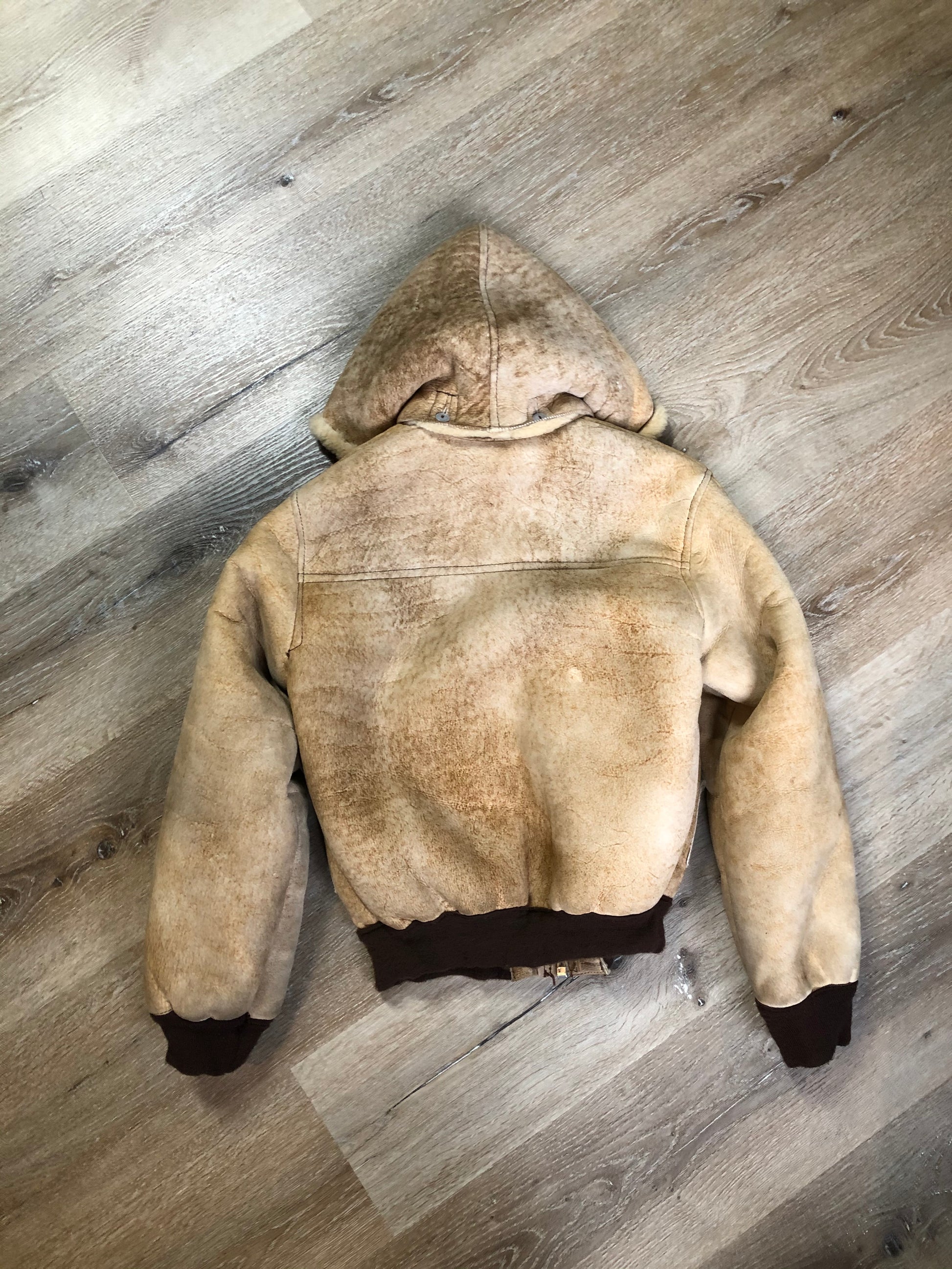 Kingspier Vintage - Ewe Wear, genuine sheepskin hooded bomber style jacket. This jacket features shearling lining, hood, zipper closure and slash pockets. Made in Kingston, Nova Scotia. Size XS.