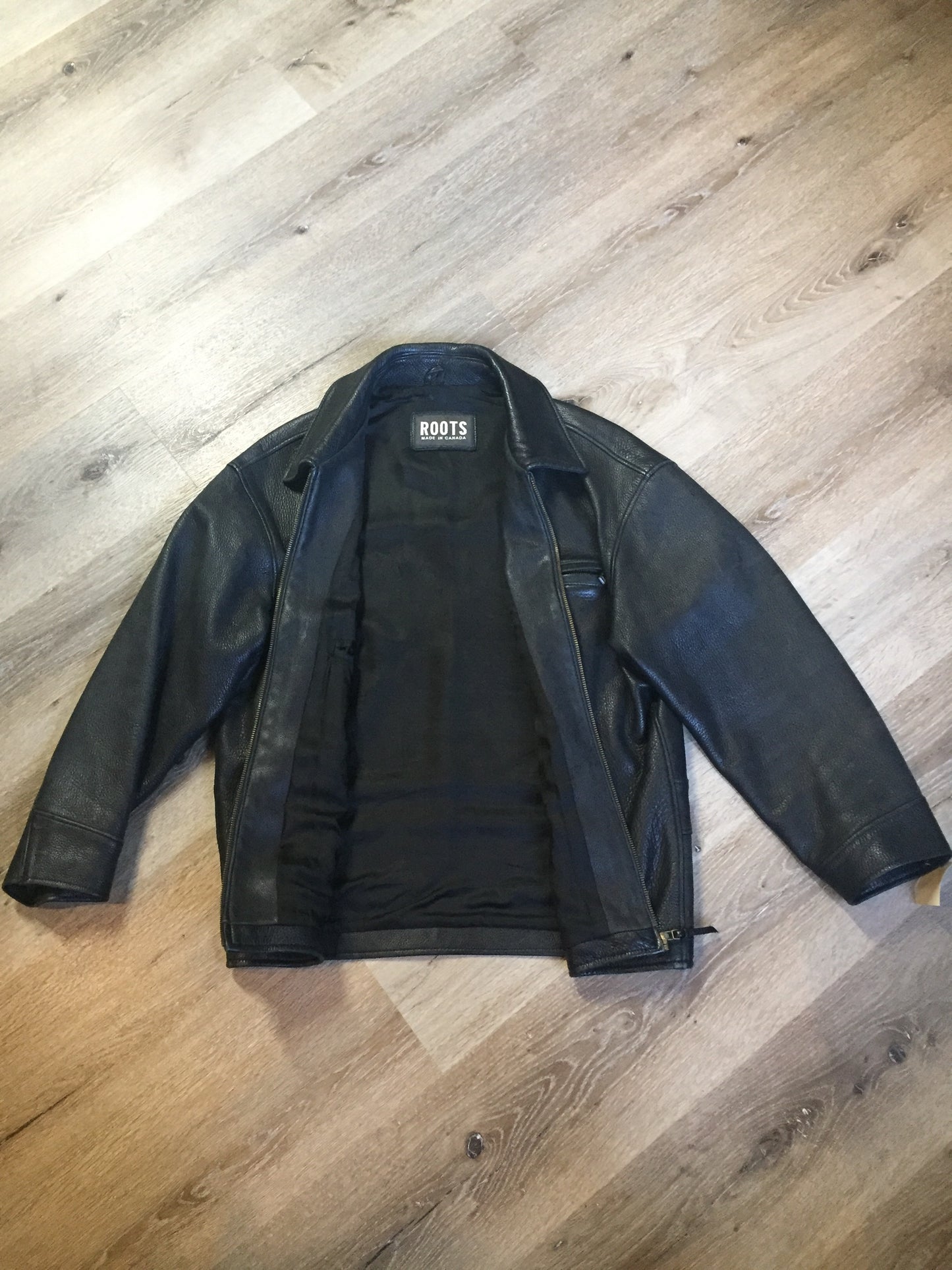 Kingspier Vintage - Roots black pebbled leather jacket with two vertical zip pockets and one zip pocket on the chest. Made in Canada. Size medium.