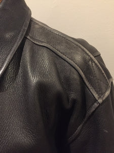 Kingspier Vintage - Black leather pilot jacket with zipper and snap closures, flap pockets, knit trim, inside pocket and plane pattern on inside lining. Size large. 