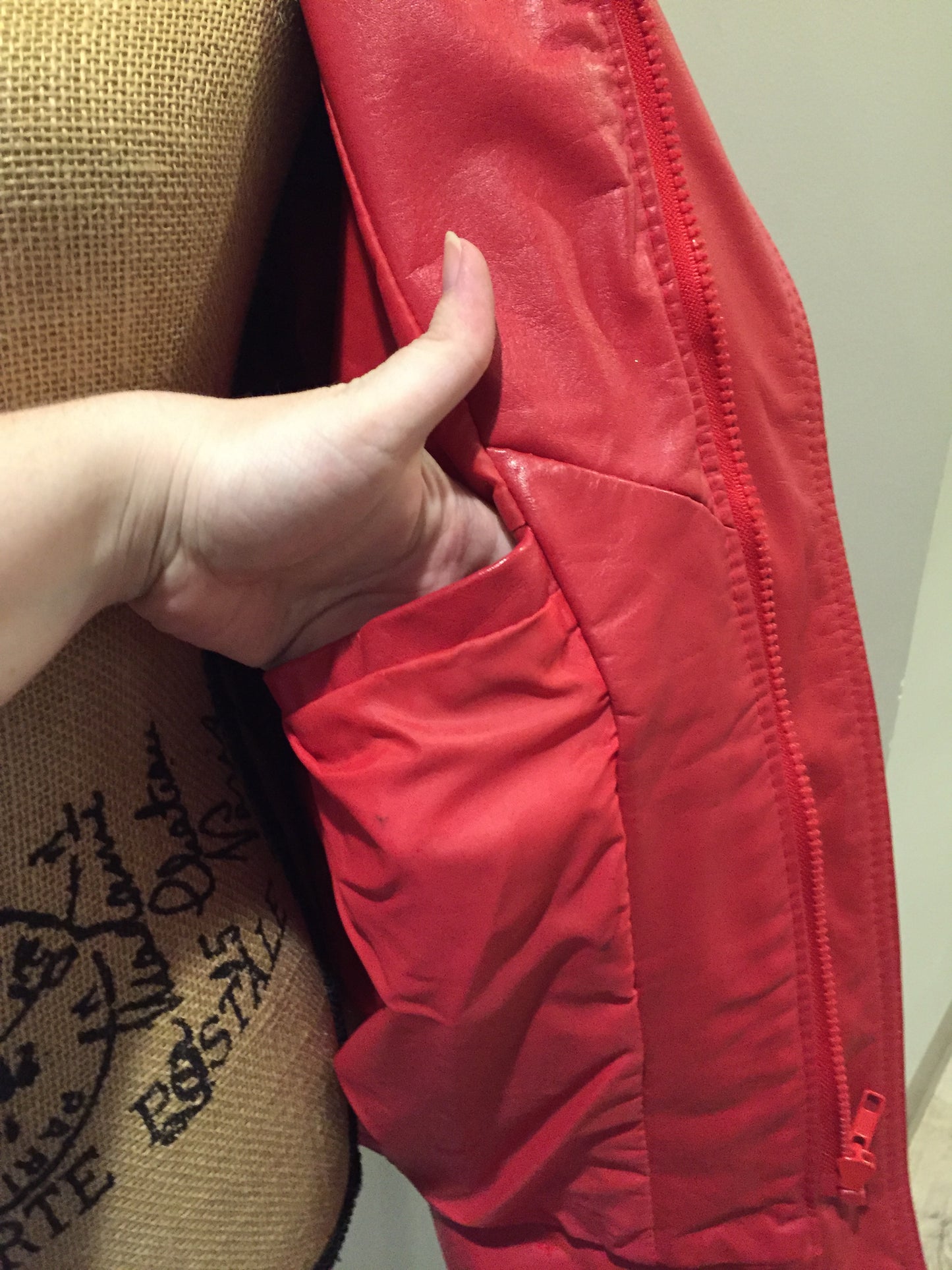 Kingspier Vintage - Zaggara Designs red leather jacket with hidden zipper, slash pockets, inside pocket and a belt at the waist. Size small.