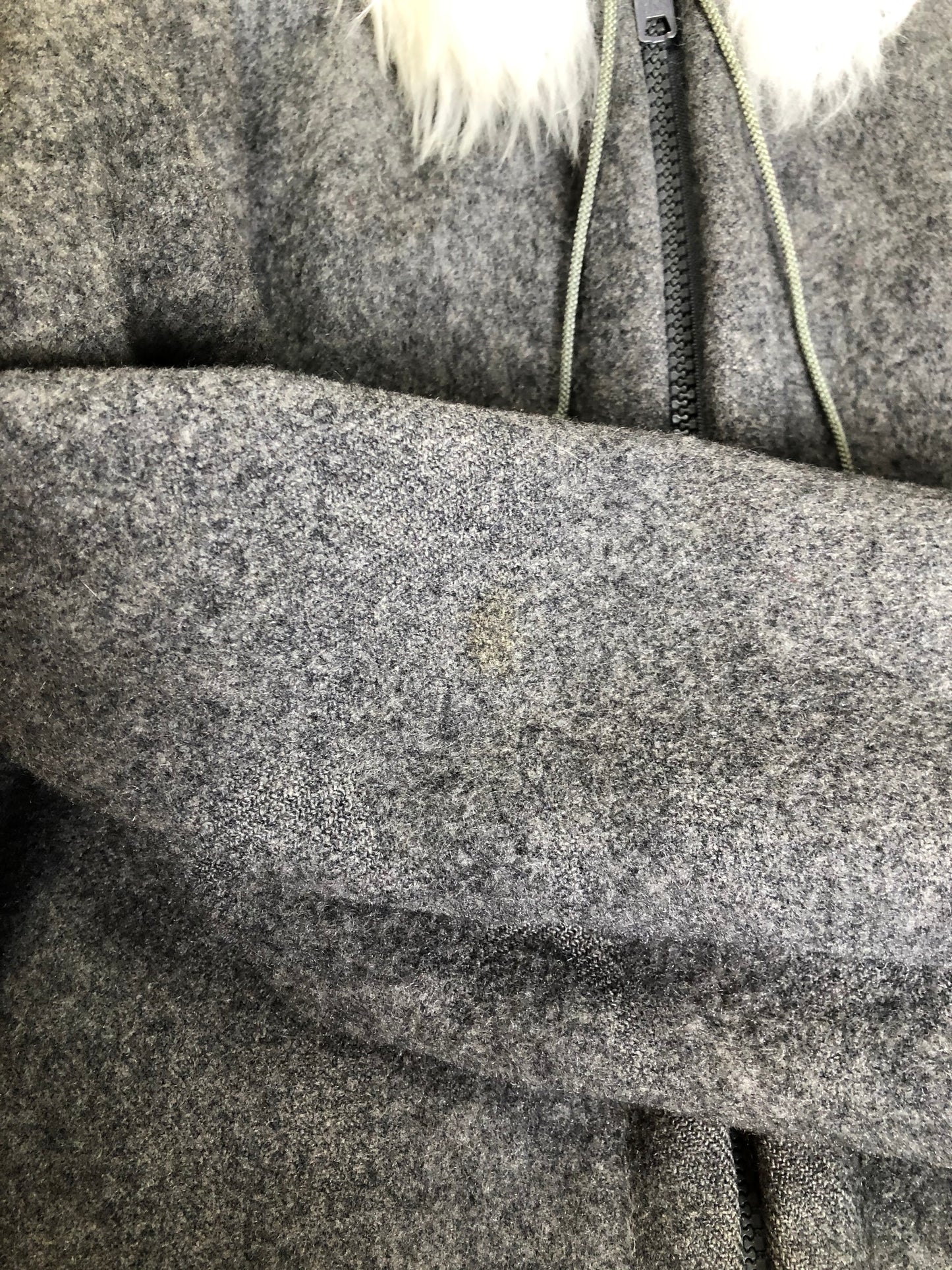 Kingspier Vintage - James Bay pure virgin wool northern parka in grey. This parka features a hood with white faux fur trim, zipper closure, quilted lining, knit inside hidden cuffs, hand stitched detail around the patch pockets and hem, felt seal appliqués in the front and a lovely arctic landscape on the back. Made in Canada.