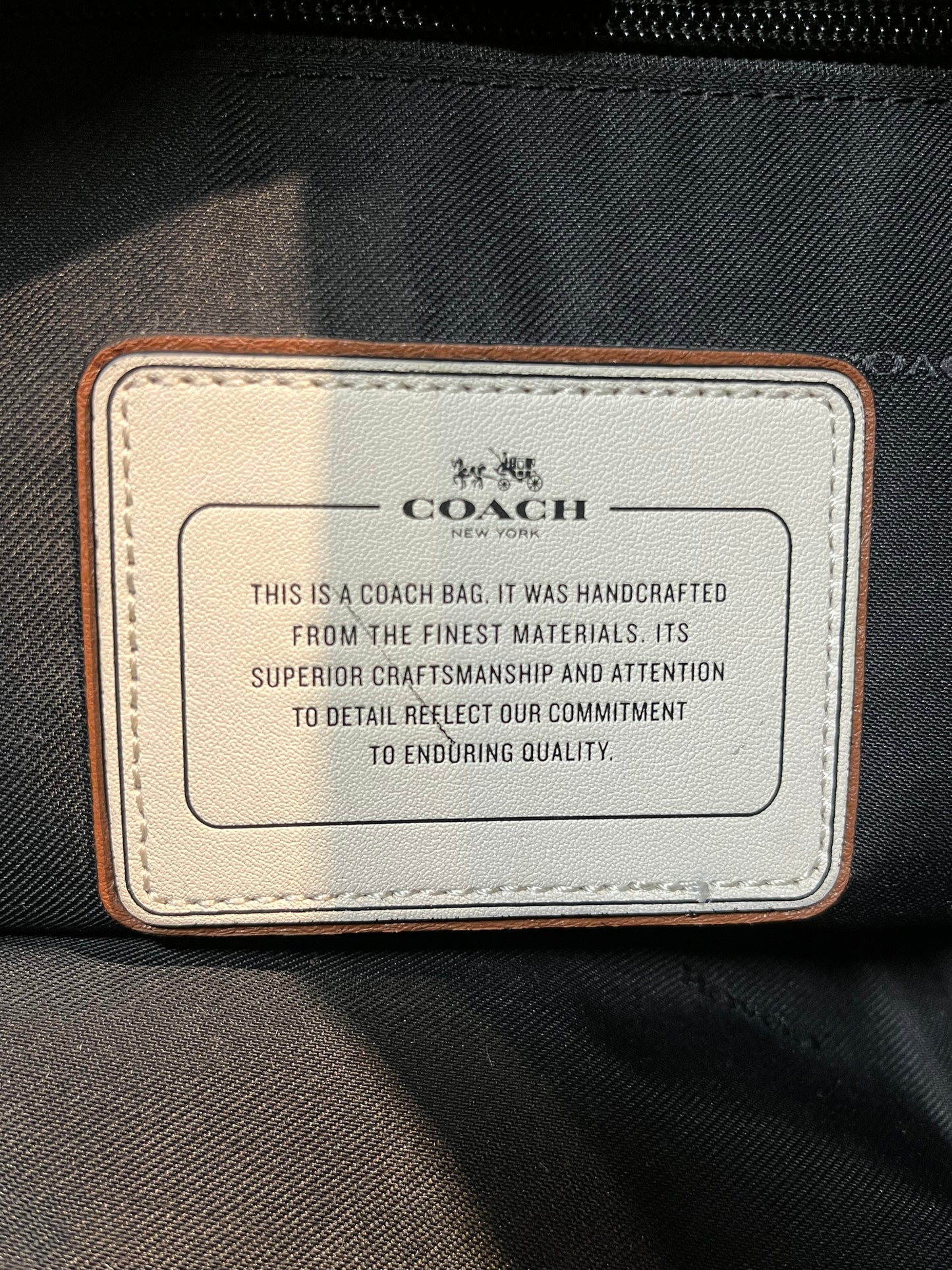 Authentic Coach brown pebble leather knapsack with adjustable shoulder straps, multiple pockets inside the large main compartment and one small compartment on the front with turn key detail.