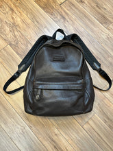 Load image into Gallery viewer, Authentic Coach brown pebble leather knapsack with adjustable shoulder straps, multiple pockets inside the large main compartment and one small compartment on the front with turn key detail.
