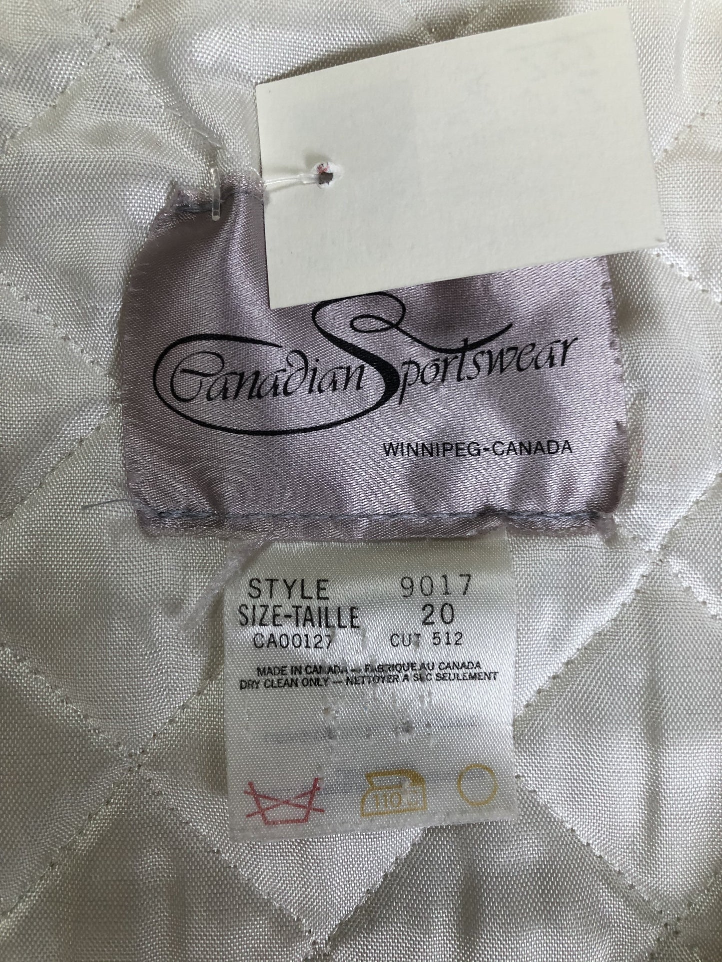 Kingspier Vintage - Canadian Sportswear pure virgin wool northern parka in cream. This parka features a hood with white fur trim, zipper closure, quilted lining, slash pockets, felt fire making design appliqués on the front and canoeing scene design on the back. Made in Canada.