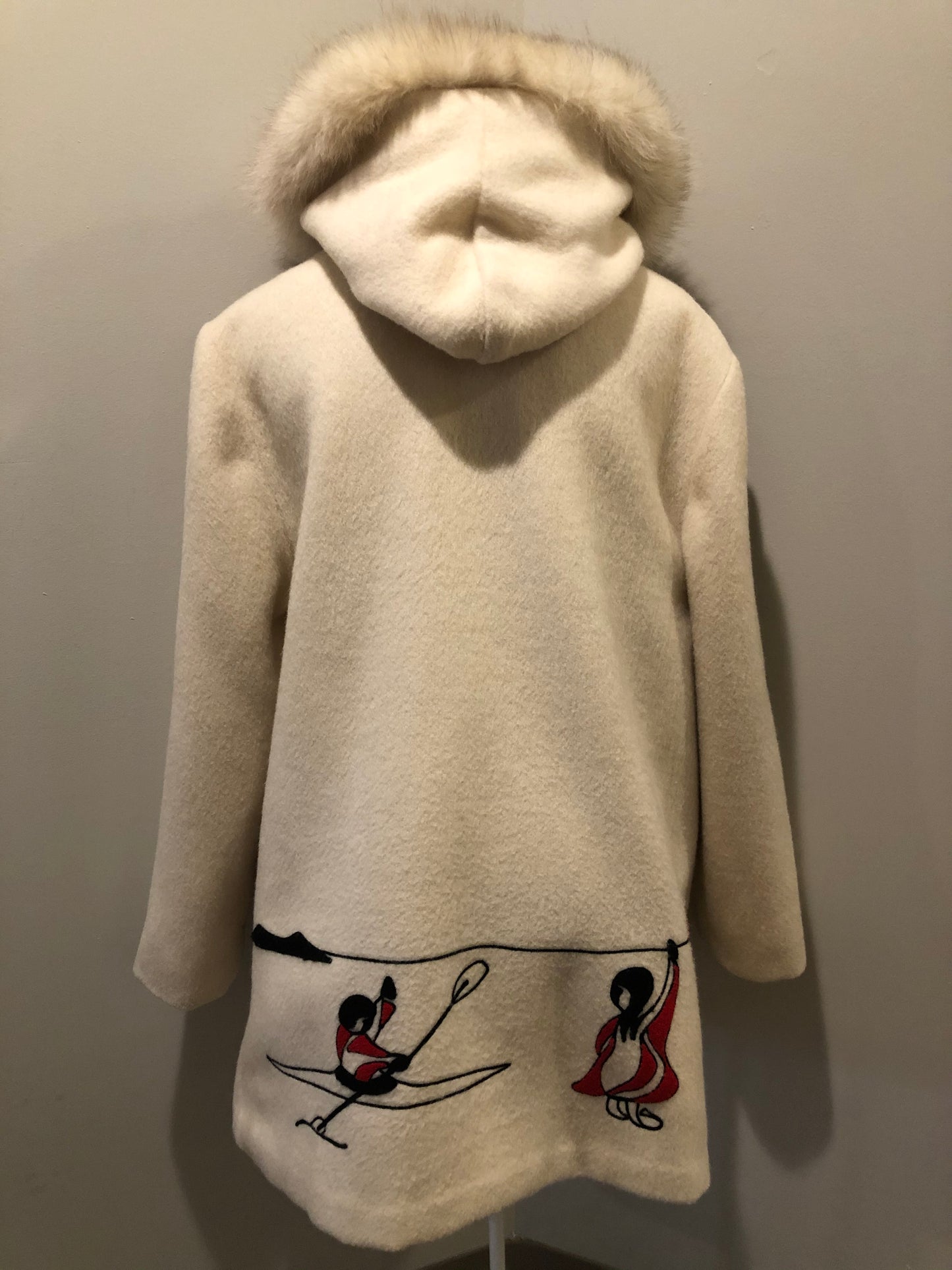 Kingspier Vintage - Canadian Sportswear pure virgin wool northern parka in cream. This parka features a hood with white fur trim, zipper closure, quilted lining, slash pockets, felt fire making design appliqués on the front and canoeing scene design on the back. Made in Canada.