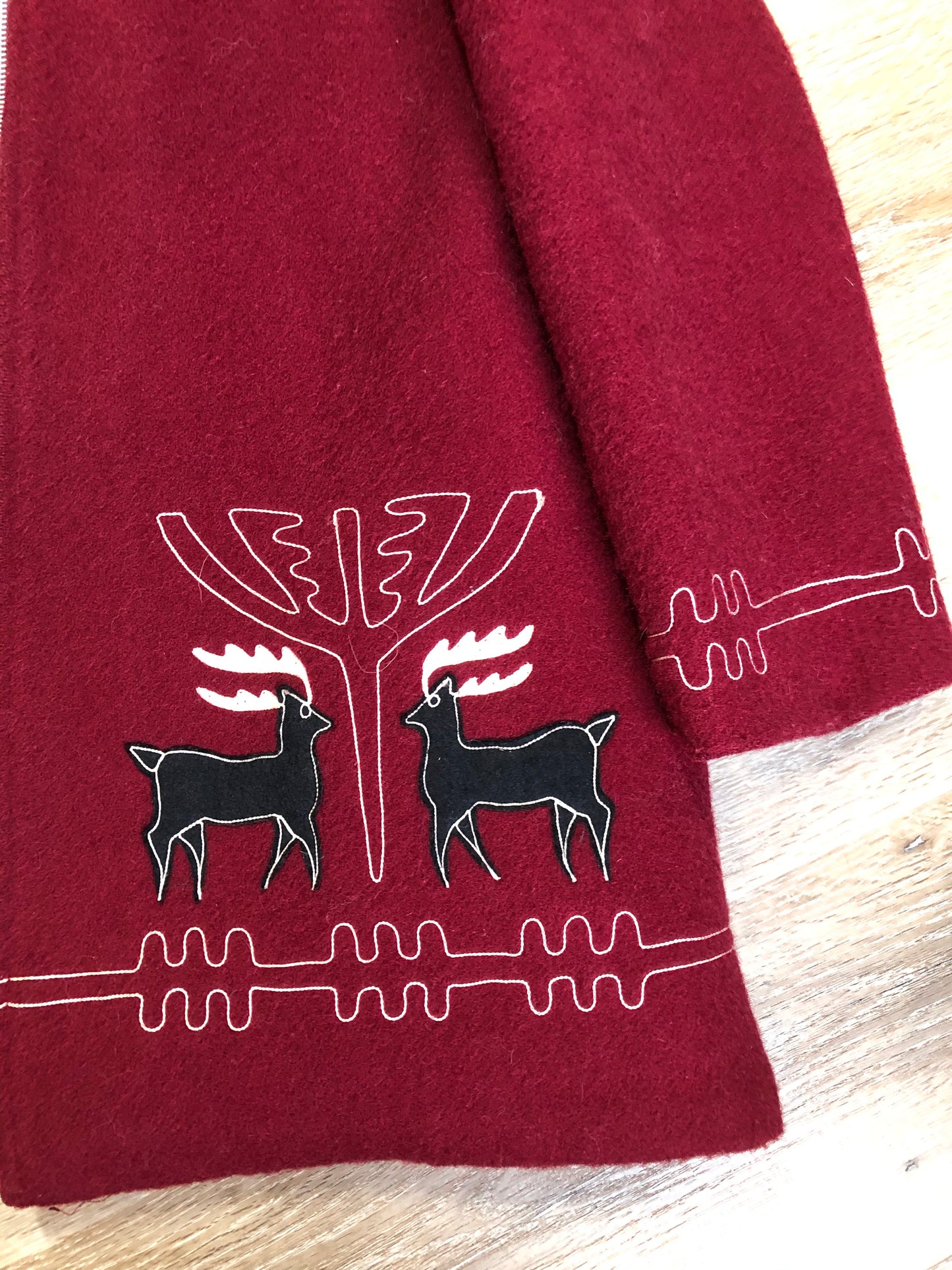 Kingspier Vintage - Sears pure virgin wool northern style parka in raspberry red. This parka features a hood with white faux fur trim, zipper closure, quilted lining, vertical pockets, hidden elastic in the lining at the wrist to keep out cold air, felt deer design appliqués on the front. Made in Canada.