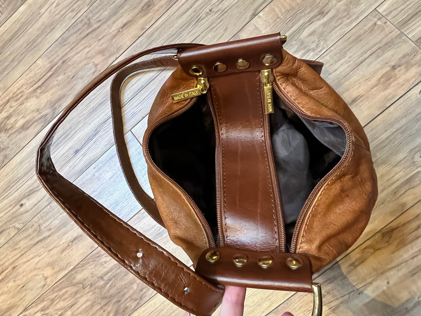 Vintage Valentino Di Paolo brown leather bucket bag/ knapsack with brass hardware, multi-pockets and multi- zip.
Made in Italy