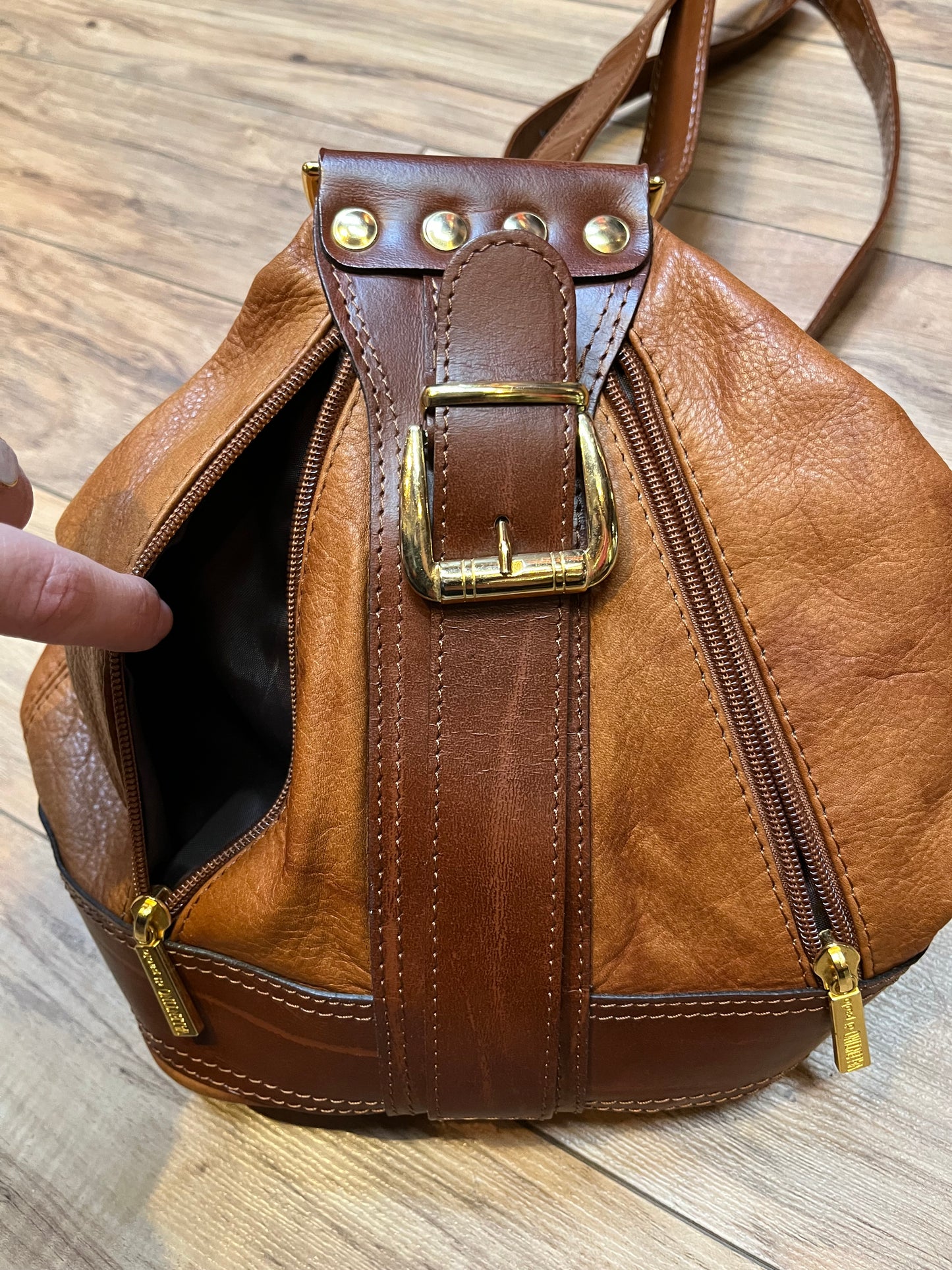 Vintage Valentino Di Paolo brown leather bucket bag/ knapsack with brass hardware, multi-pockets and multi- zip.
Made in Italy