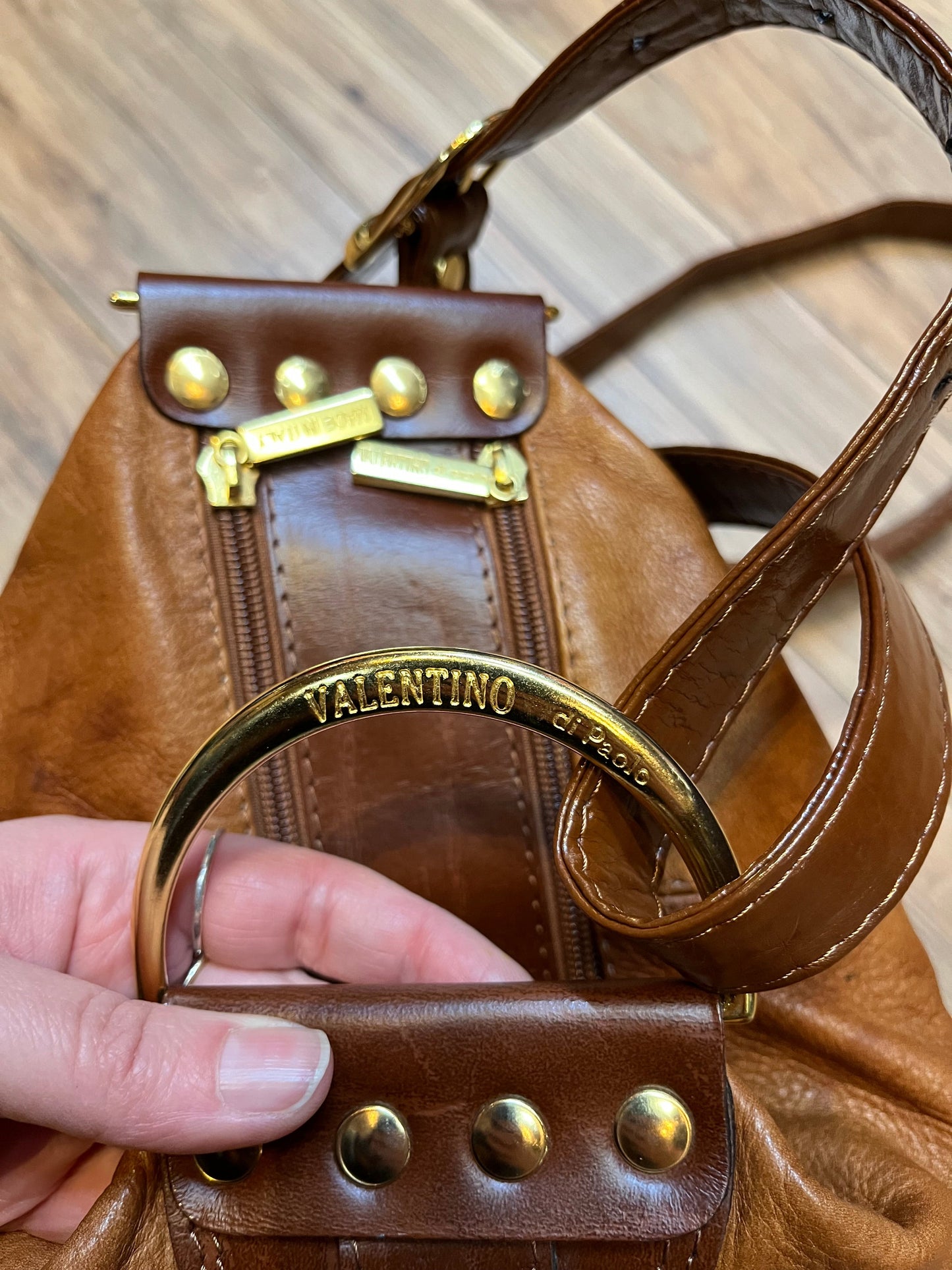 Vintage Valentino Di Paolo brown leather bucket bag/ knapsack with brass hardware, multi-pockets and multi- zip.
Made in Italy