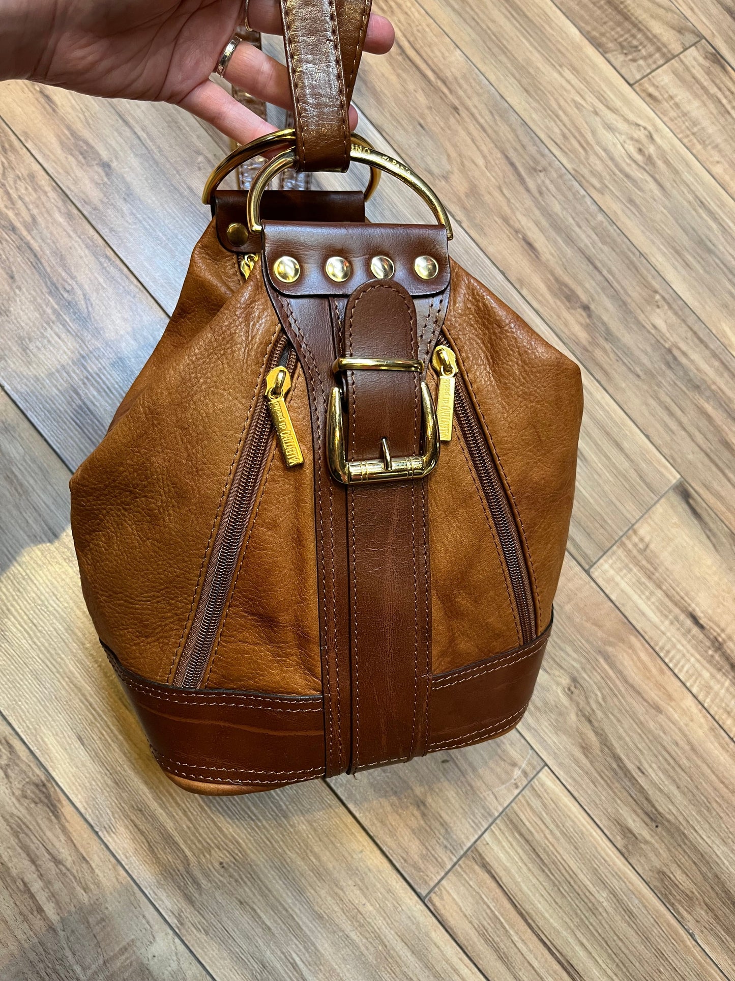 Vintage Valentino Di Paolo brown leather bucket bag/ knapsack with brass hardware, multi-pockets and multi- zip.
Made in Italy