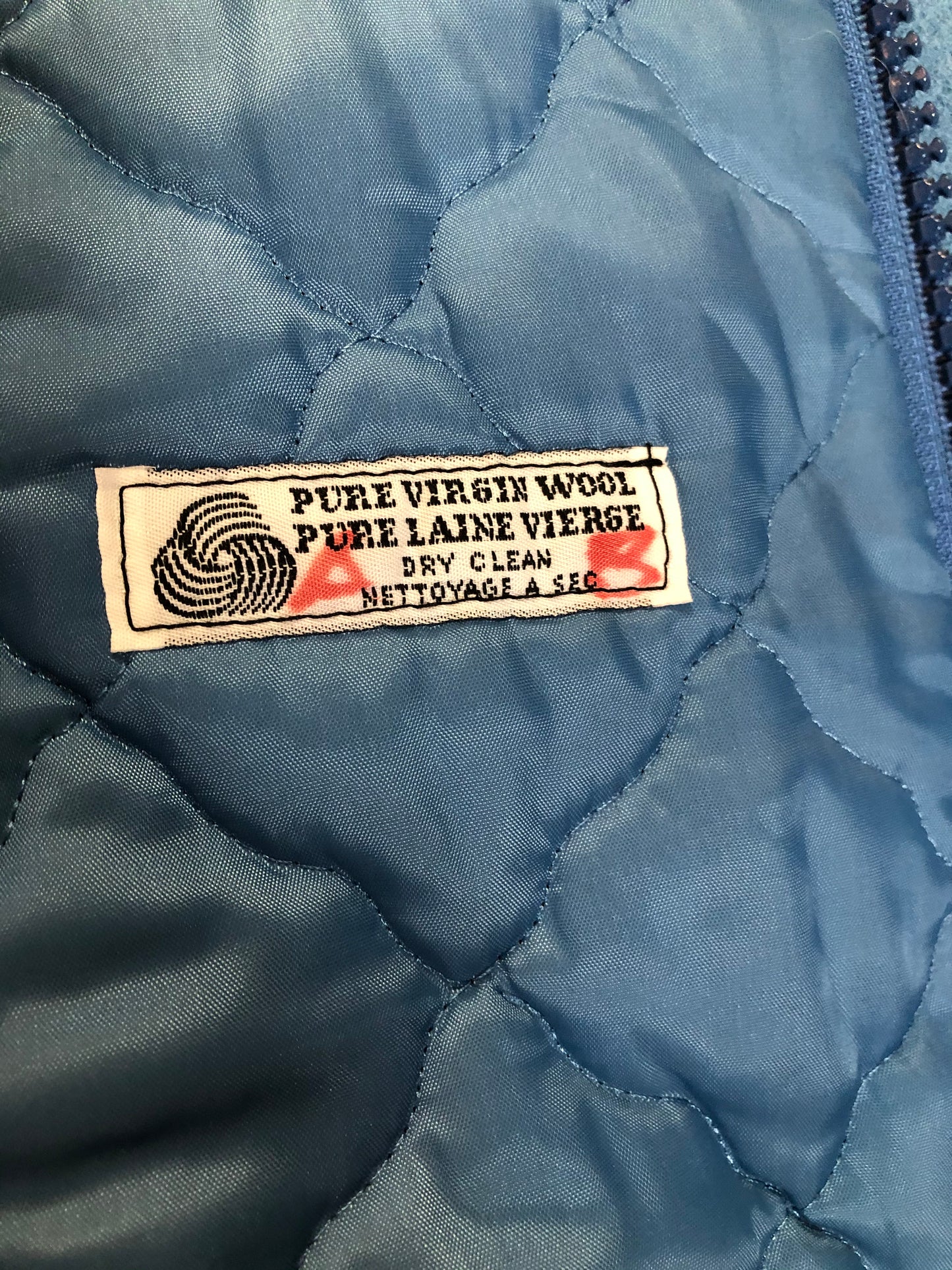 Kingspier Vintage - Northern Sun pure virgin wool northern parka in light blue. This parka features a hood with white fur trim, zipper closure, quilted lining, slash pockets, hidden inside knit cuffs, embroidered polar bear design on the front and back. Made in Canada.