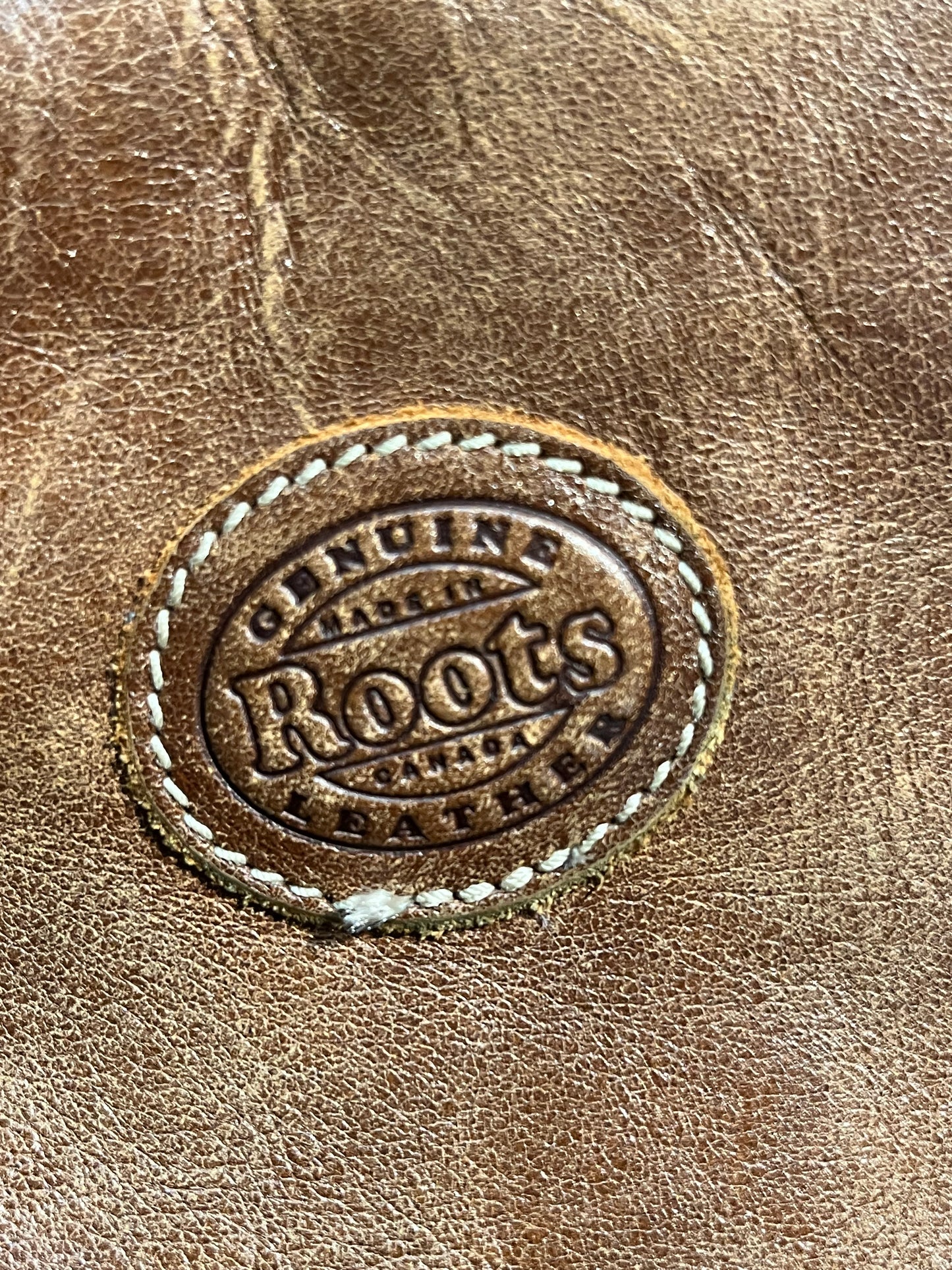Vintage Roots Tribal Leather brown knapsack with adjustable shoulder straps, drawstring and buckle closures, one large main compartment and three small outer pockets.
Made in Canada