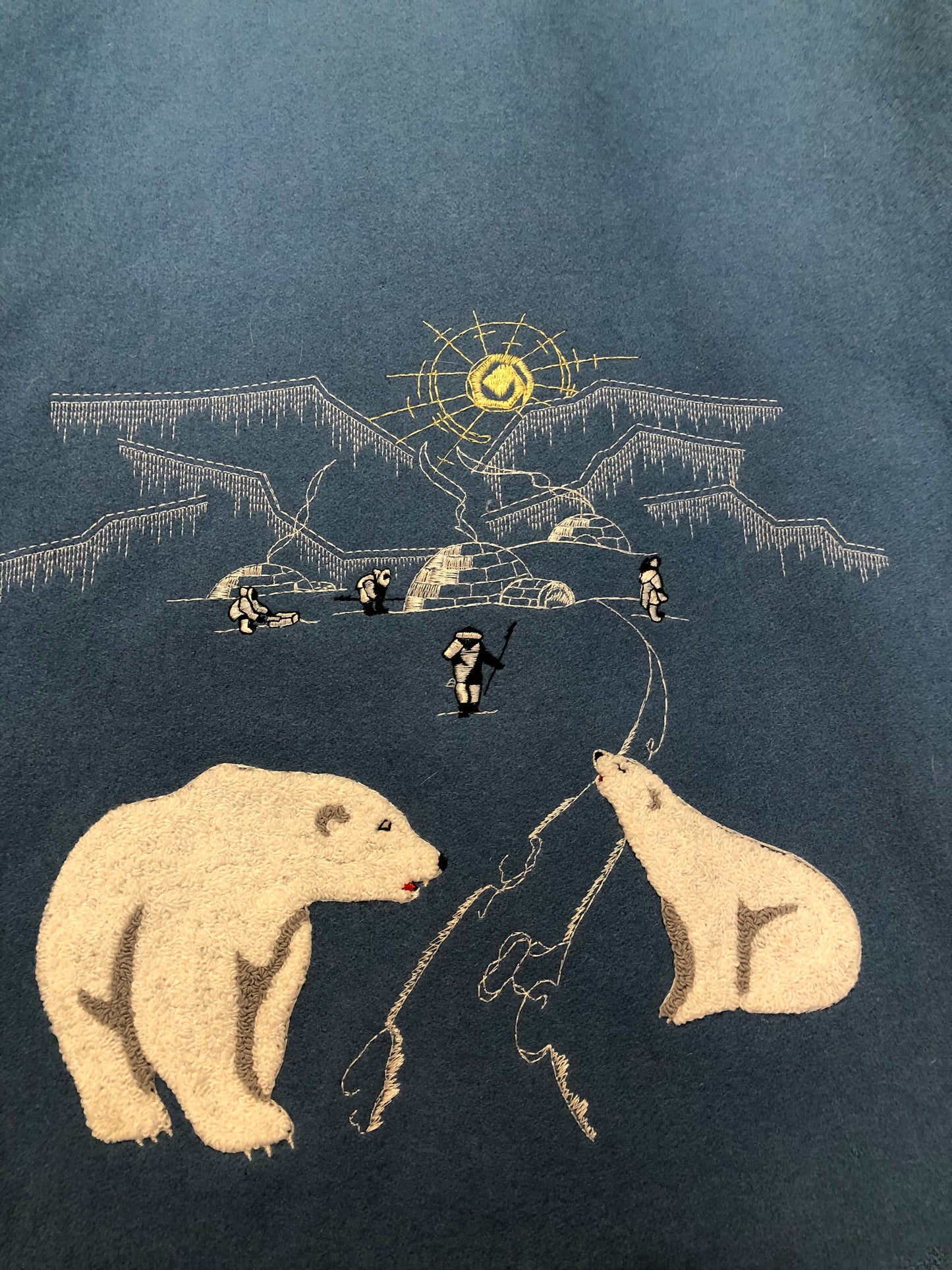 Kingspier Vintage - Northern Sun pure virgin wool northern parka in light blue. This parka features a hood with white fur trim, zipper closure, quilted lining, slash pockets, hidden inside knit cuffs, embroidered polar bear design on the front and back. Made in Canada.