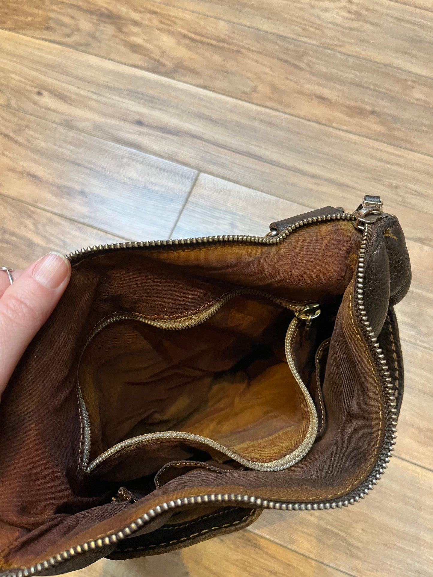 Vintage Roots Tribal Leather brown crossbody bag with adjustable shoulder strap, multiple compartments and turn key detail.