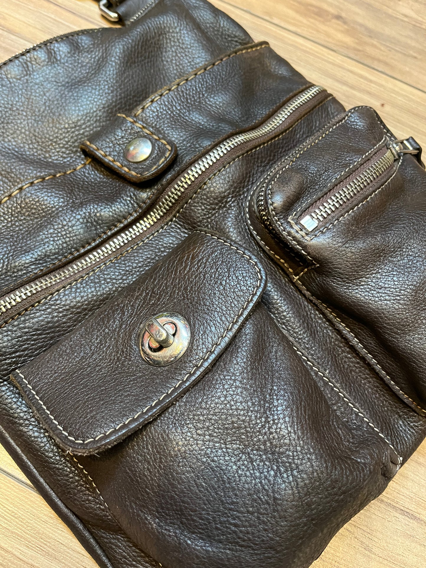 Vintage Roots Tribal Leather brown crossbody bag with adjustable shoulder strap, multiple compartments and turn key detail.
