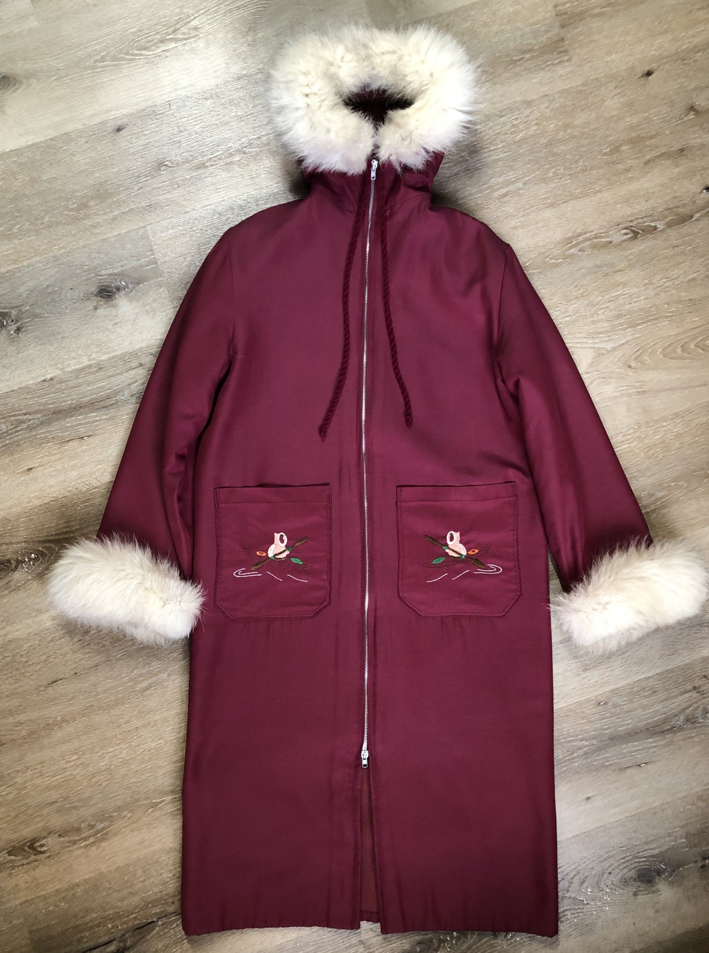 Kingspier Vintage - Pink Northern parka with wool blend lining, hood and sleeves with white fur trim, fur Pom poms, zipper closure, patch pockets, canoe design embroidered on the front pockets. Made in Canada.