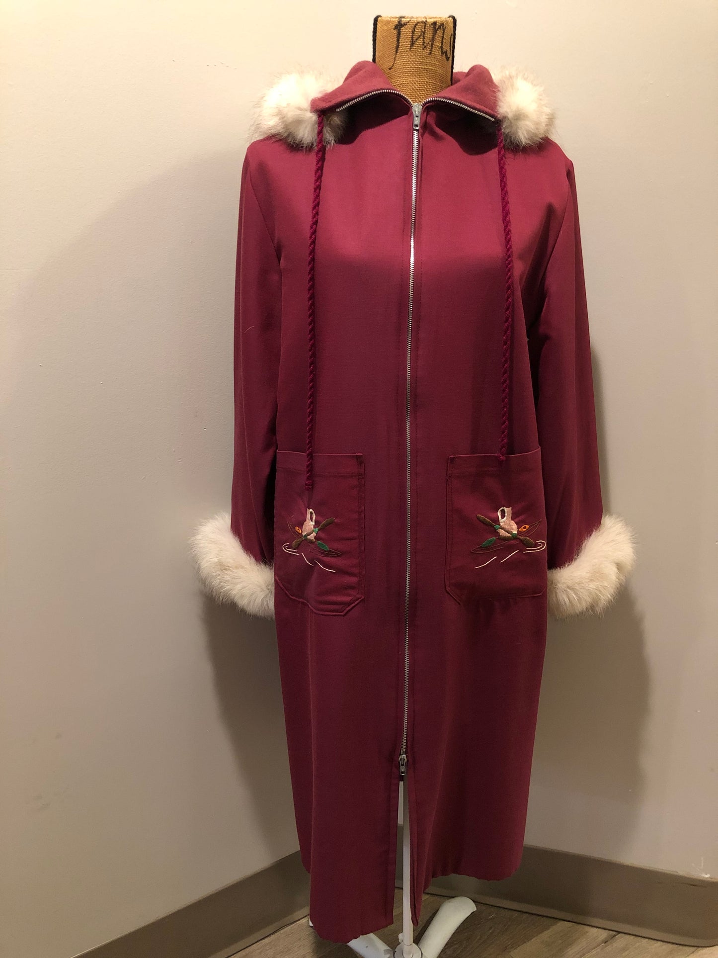 Kingspier Vintage - Pink Northern parka with wool blend lining, hood and sleeves with white fur trim, fur Pom poms, zipper closure, patch pockets, canoe design embroidered on the front pockets. Made in Canada.