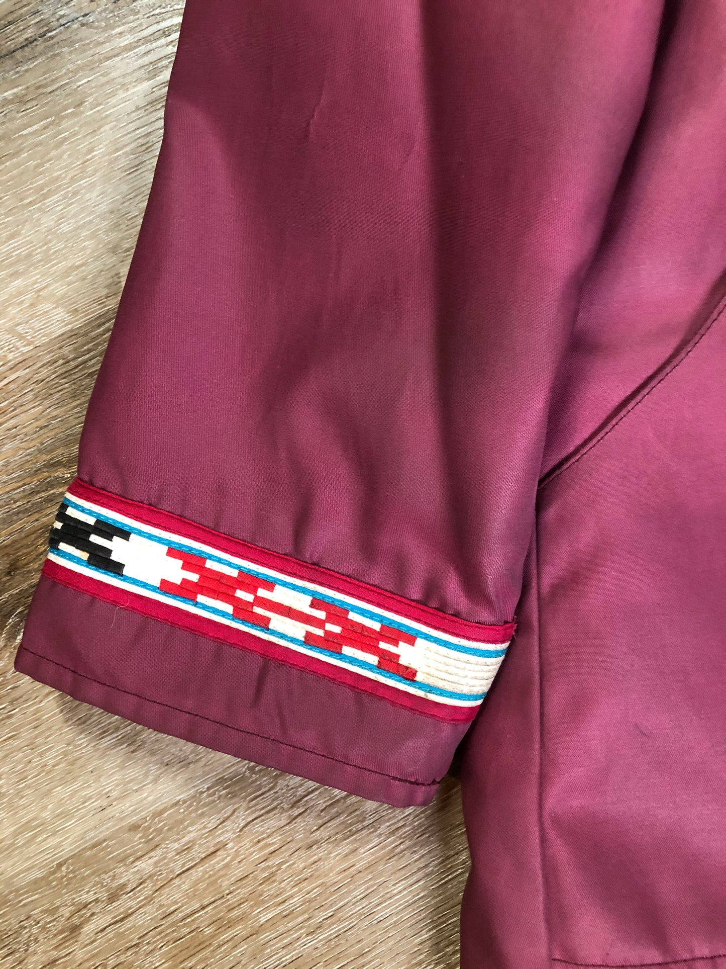 Kingspier Vintage - “Styles North” pink northern parka with removable outer shell featuring a hood with white fur trim, zipper closure, lining, patch pockets, felt warrior appliqué design on the front and back. Made in Canada.
