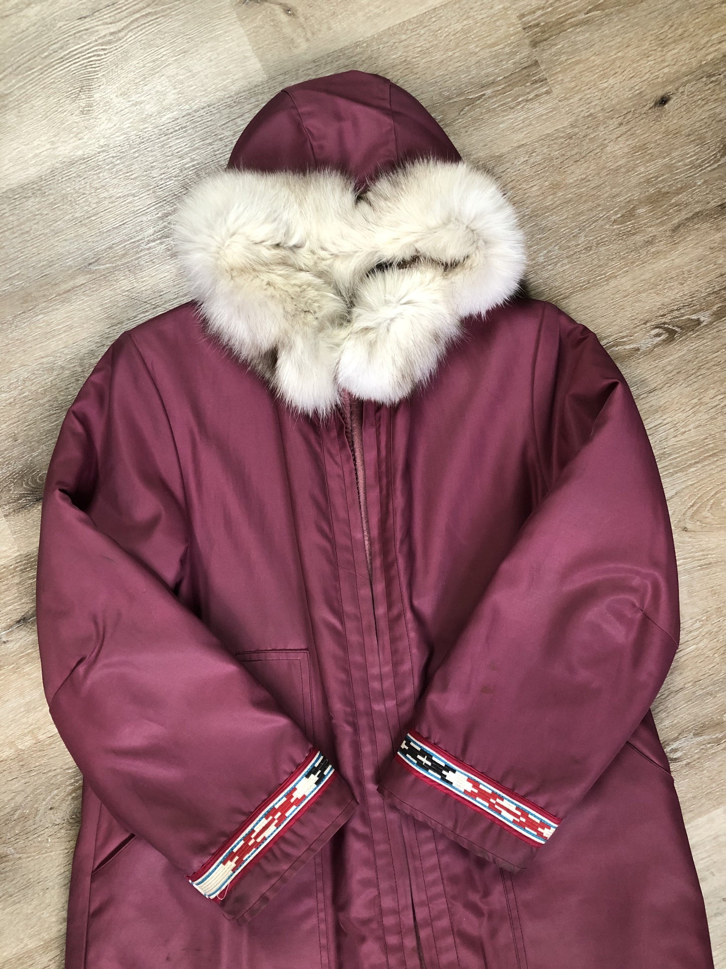 Kingspier Vintage - “Styles North” pink northern parka with removable outer shell featuring a hood with white fur trim, zipper closure, lining, patch pockets, felt warrior appliqué design on the front and back. Made in Canada.