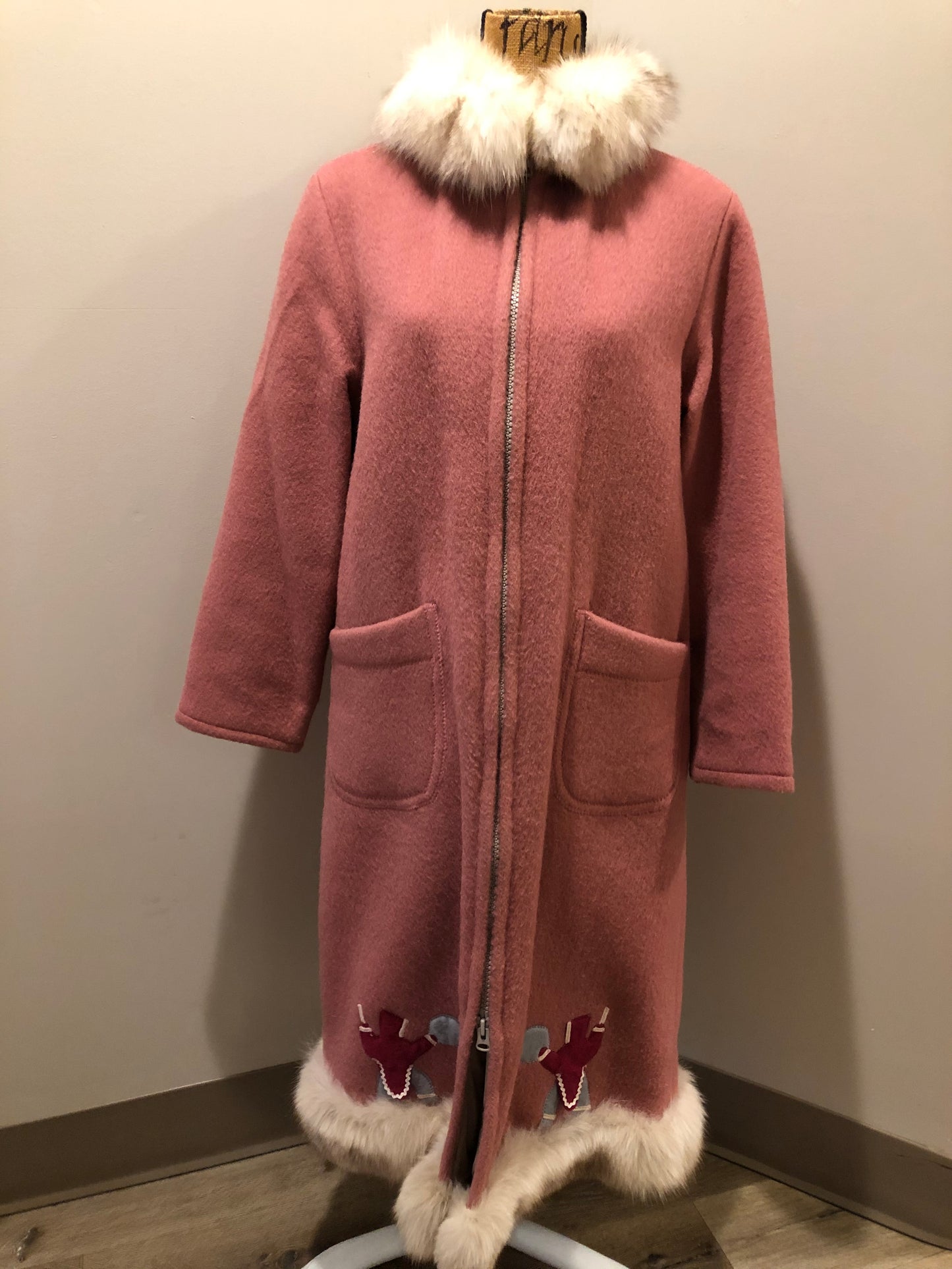 Kingspier Vintage - “Styles North” pink northern parka with removable outer shell featuring a hood with white fur trim, zipper closure, lining, patch pockets, felt warrior appliqué design on the front and back. Made in Canada.