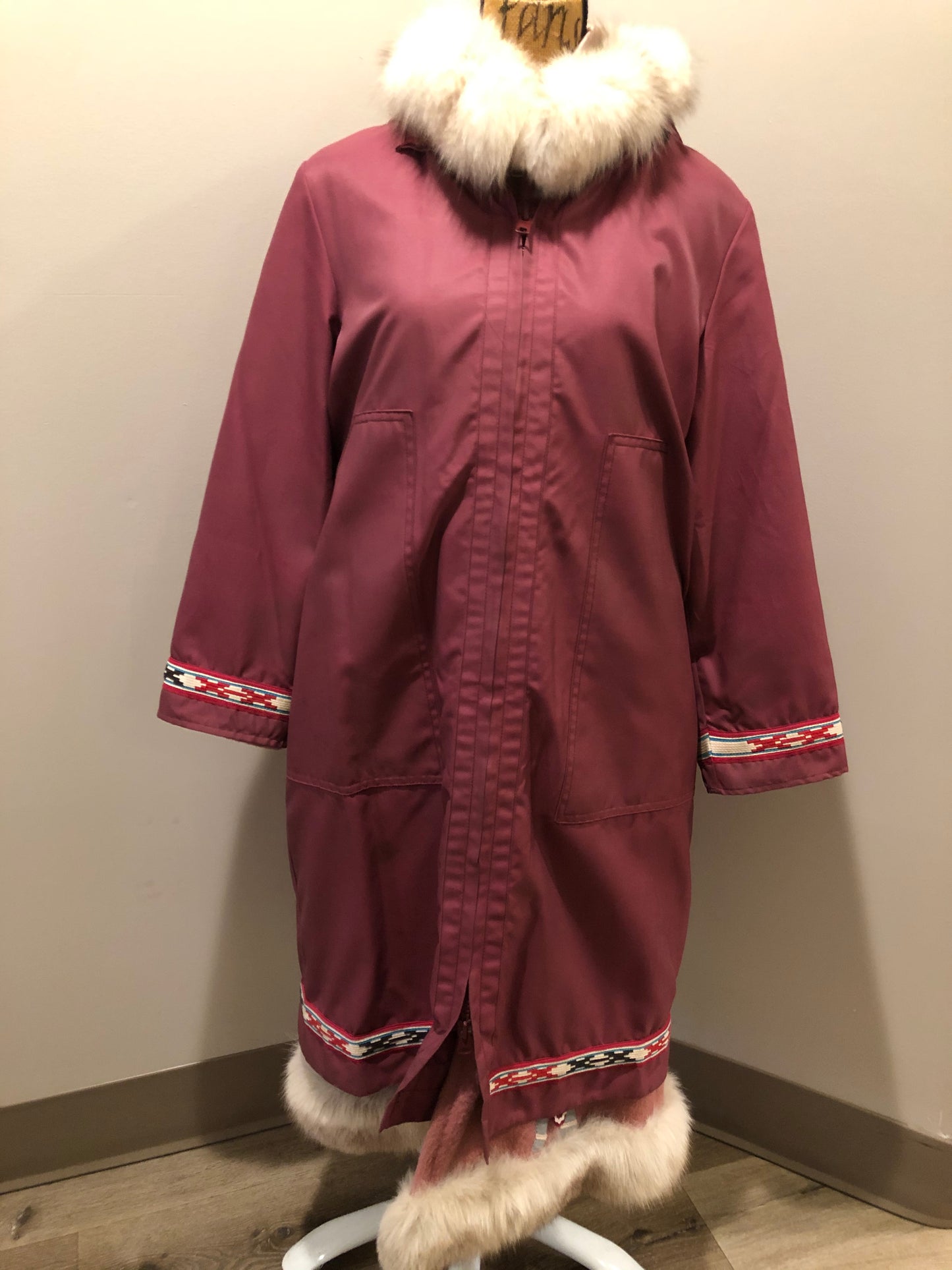 Kingspier Vintage - “Styles North” pink northern parka with removable outer shell featuring a hood with white fur trim, zipper closure, lining, patch pockets, felt warrior appliqué design on the front and back. Made in Canada.