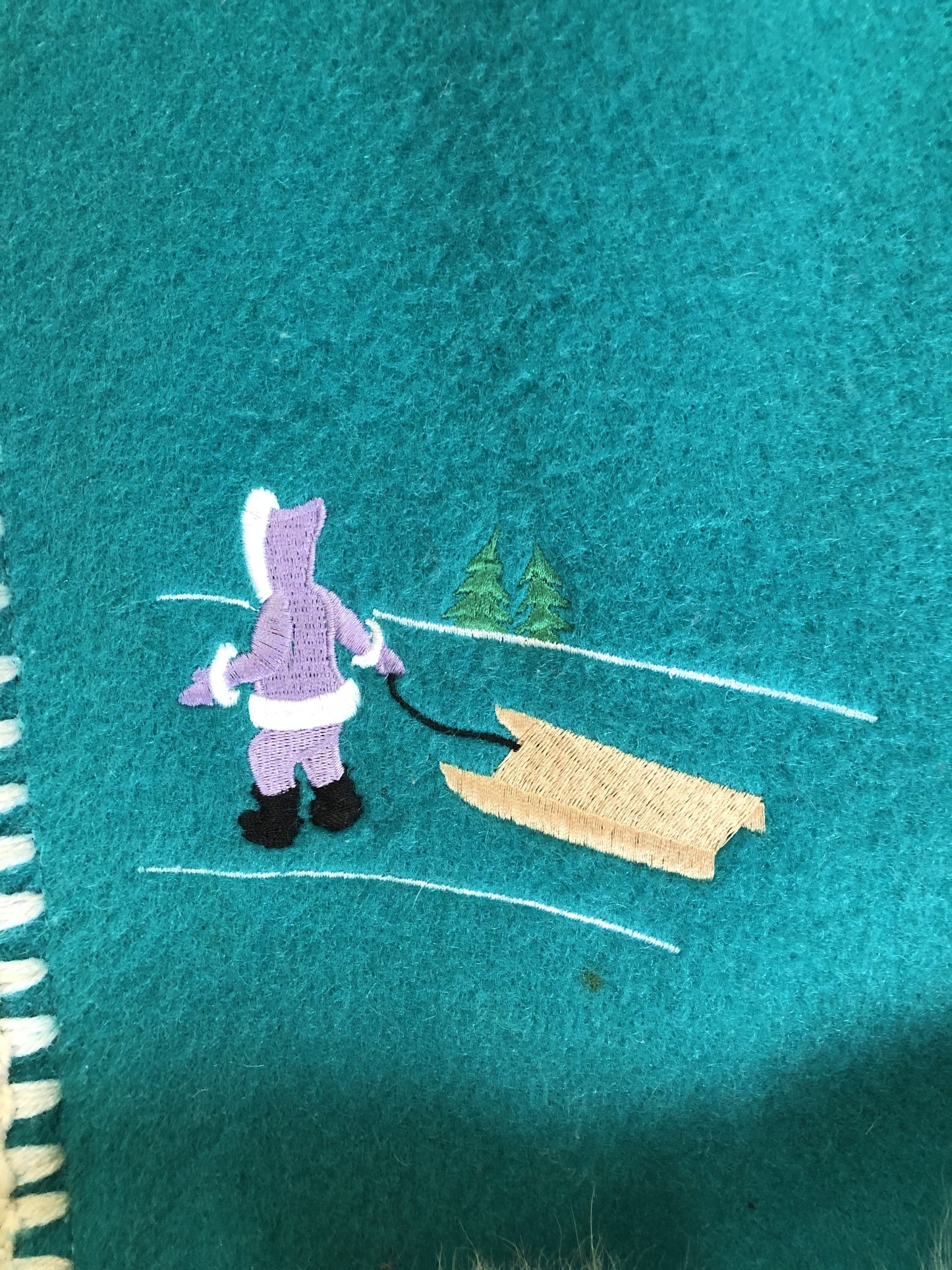 Kingspier Vintage - Children’s Turquoise Wool Humber Handcrafts northern parka featuring a hood, white fur trim, zipper closure, lining, embroidered winter scenes along the front. Made in Canada.