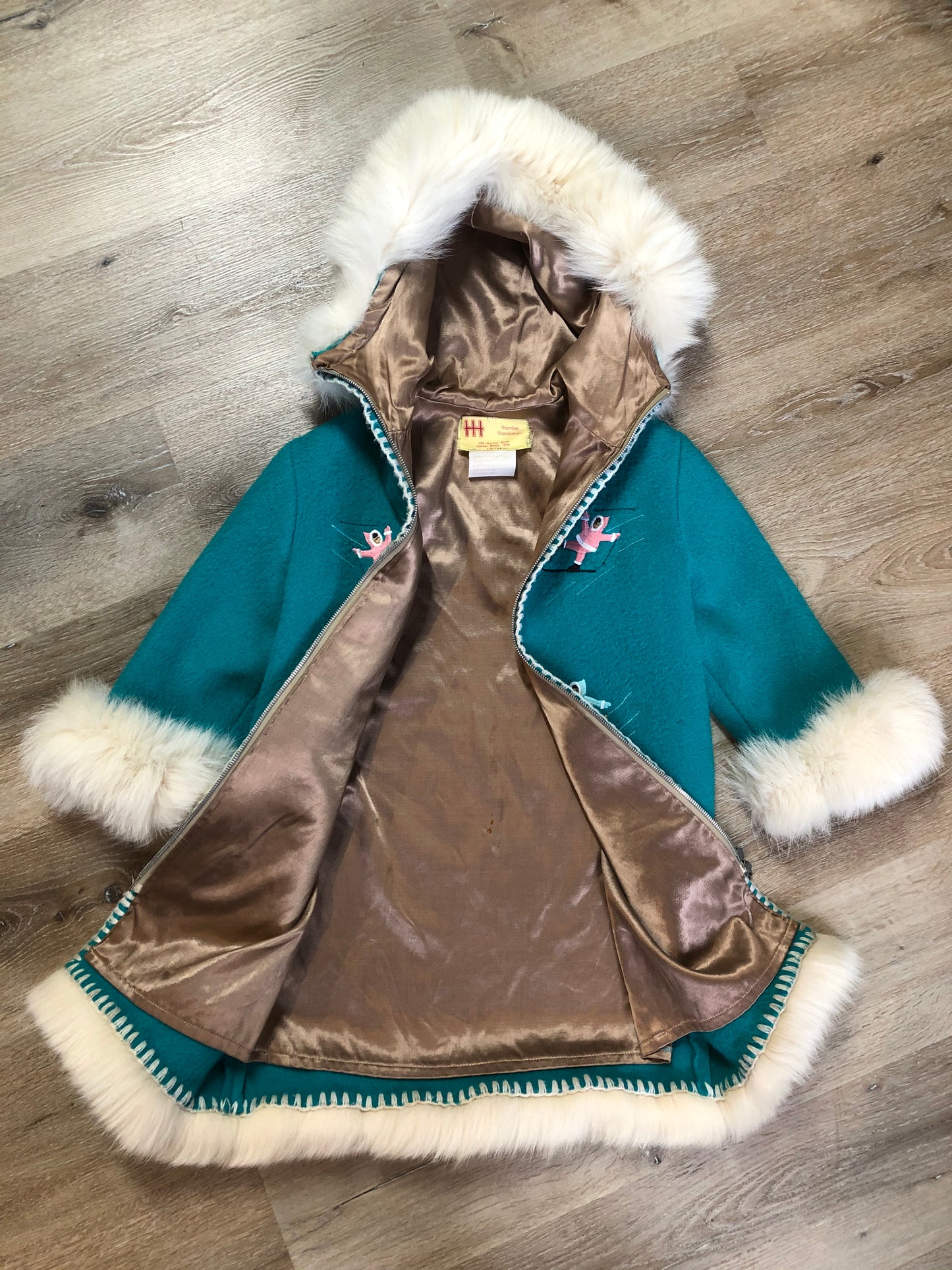 Kingspier Vintage - Children’s Turquoise Wool Humber Handcrafts northern parka featuring a hood, white fur trim, zipper closure, lining, embroidered winter scenes along the front. Made in Canada.