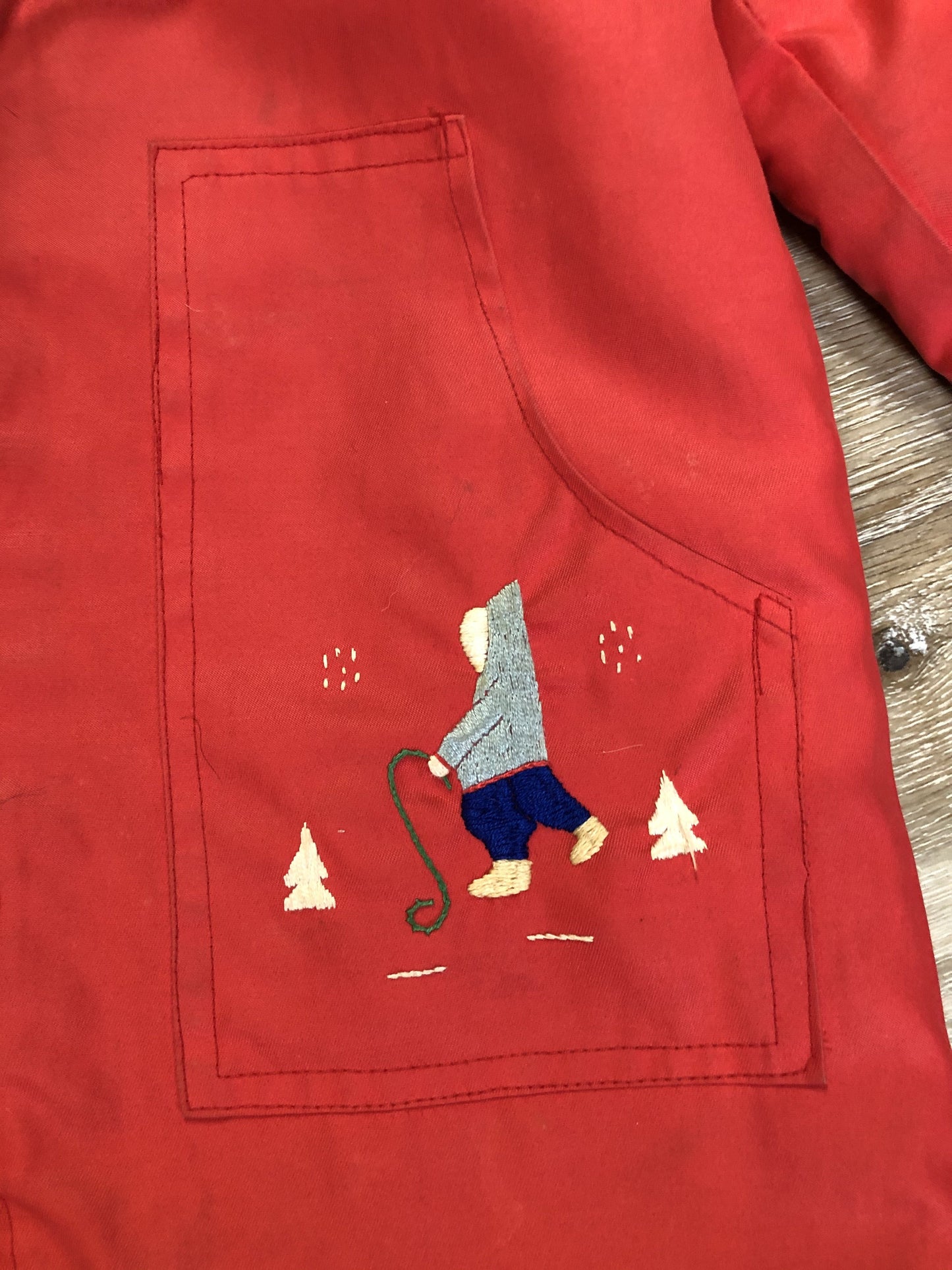 Kingspier Vintage - Children’s red northern parka featuring a hood, fur trim and pom poms, zipper closure, wool lining, patch pockets, embroidered winter scenes along the front. Made in Canada.