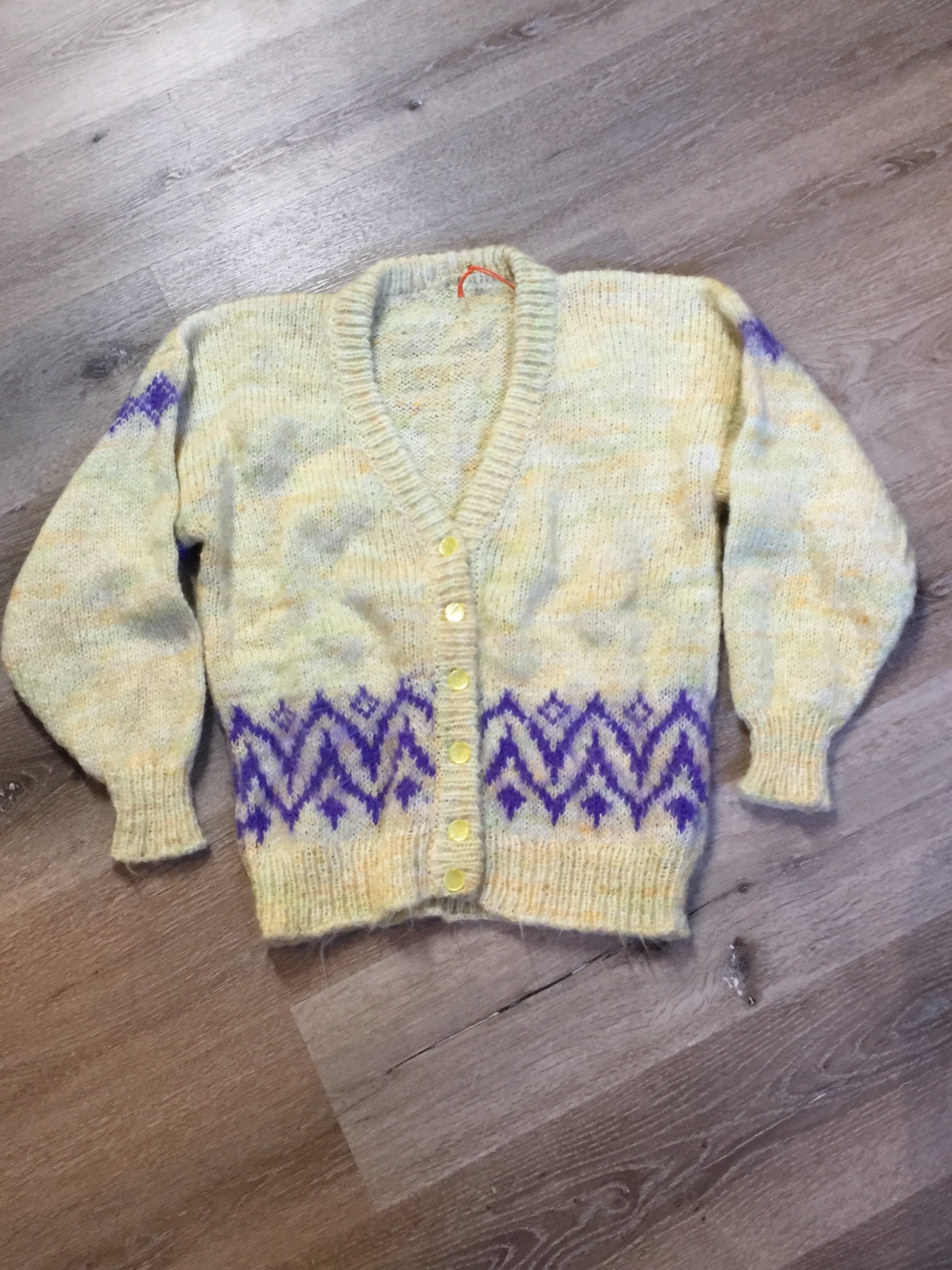 Kingspier Vintage - Hand knit cardigan in pale yellow with purple design and button closures. Size medium.