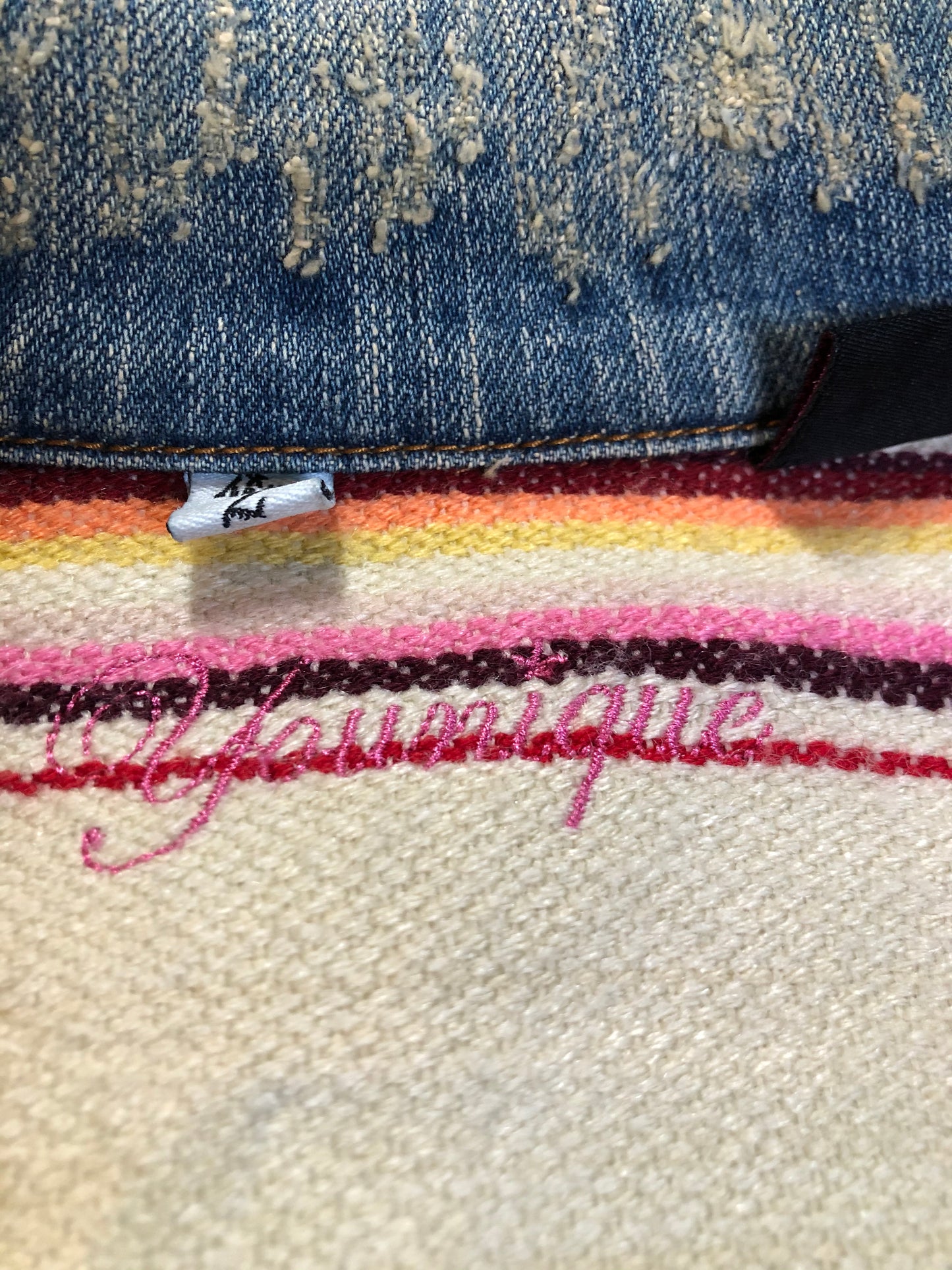 Kingspier Vintage - Younique denim jacket in a distressed light wash with colourful striped wool blend lining, button closures and two flap pockets. Size large, fits more like a medium.