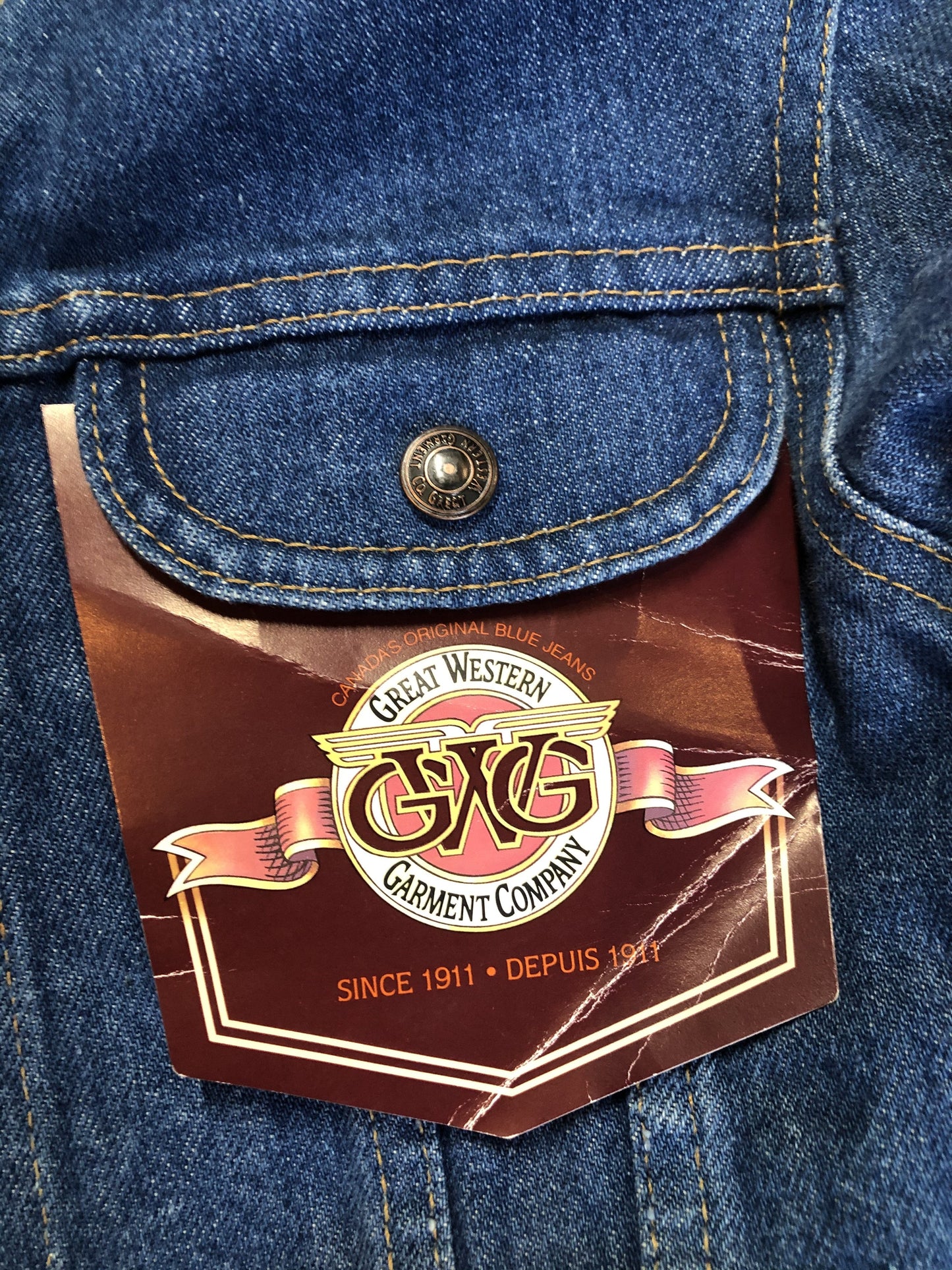 Kingspier Vintage - GWG (Great Western Garment Co.) denim jacket in a medium wash with snap closures and two flap pockets on the chest. Says size 12 fits XS. Canadian company.